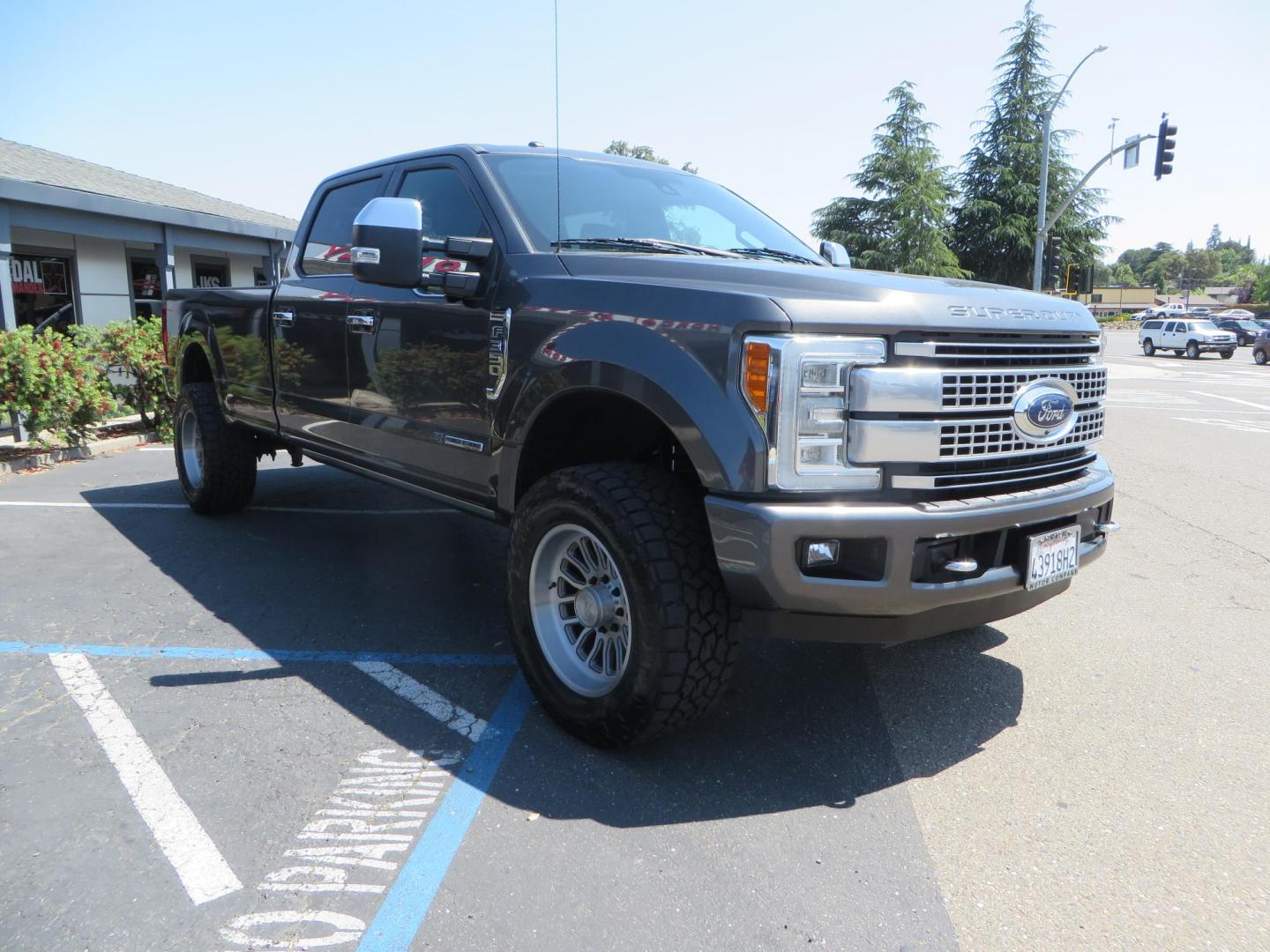 2017 Charcoal Ford F350 Super Duty Crew Cab Platinum Crew Cab Long Bed 4WD (1FT8W3BT5HE) with an V8 Turbo Diesel 6.7L engine, Auto HD 6-Spd SelShft transmission, located at 2630 Grass Valley Highway, Auburn, CA, 95603, (530) 508-5100, 38.937893, -121.095482 - Leveled Long Bed Platinum Superduty sitting on 20" Asanti wheels and Toyo AT3 tires. - Photo#2