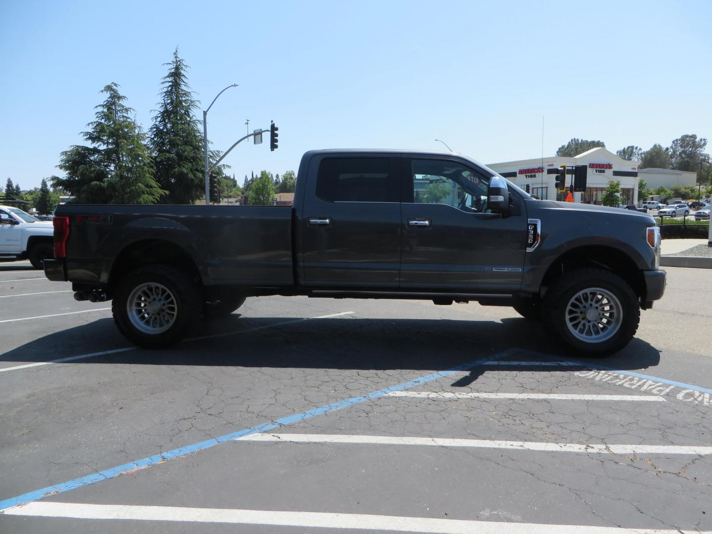 2017 Charcoal Ford F350 Super Duty Crew Cab Platinum Crew Cab Long Bed 4WD (1FT8W3BT5HE) with an V8 Turbo Diesel 6.7L engine, Auto HD 6-Spd SelShft transmission, located at 2630 Grass Valley Highway, Auburn, CA, 95603, (530) 508-5100, 38.937893, -121.095482 - Leveled Long Bed Platinum Superduty sitting on 20" Asanti wheels and Toyo AT3 tires. - Photo#3