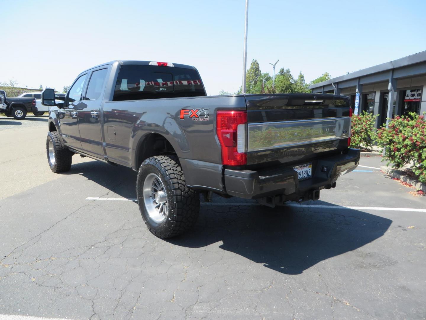 2017 Charcoal Ford F350 Super Duty Crew Cab Platinum Crew Cab Long Bed 4WD (1FT8W3BT5HE) with an V8 Turbo Diesel 6.7L engine, Auto HD 6-Spd SelShft transmission, located at 2630 Grass Valley Highway, Auburn, CA, 95603, (530) 508-5100, 38.937893, -121.095482 - Leveled Long Bed Platinum Superduty sitting on 20" Asanti wheels and Toyo AT3 tires. - Photo#6