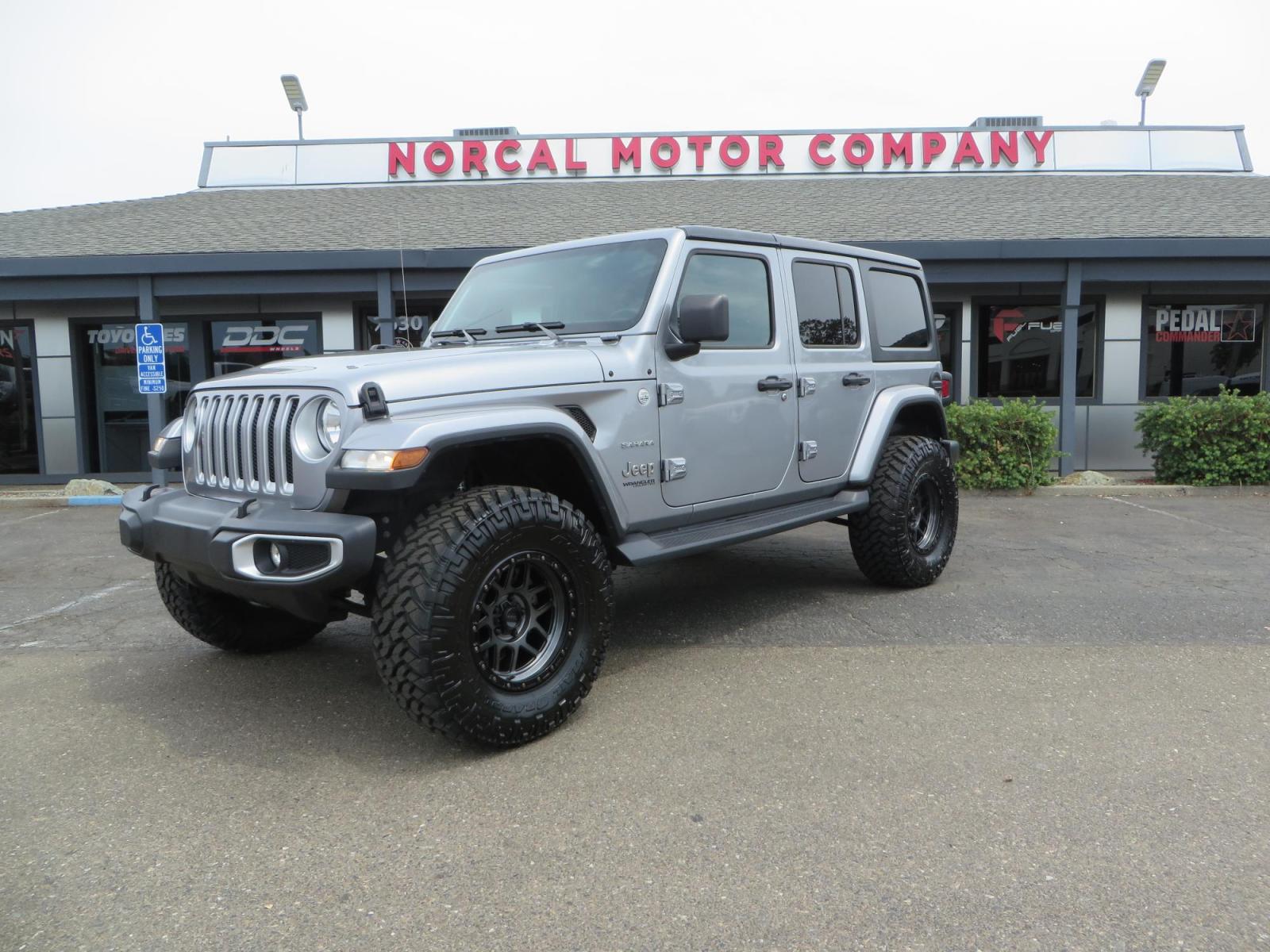 2020 Silver Jeep Wrangler Unlimited Sahara Sport Utility 4D (1C4HJXEN5LW) with an 4-Cyl eTorque Turbo 2.0 Liter engine, Automatic 8-Spd transmission, located at 2630 Grass Valley Highway, Auburn, CA, 95603, (530) 508-5100, 38.937893, -121.095482 - 3" Zone offroad lift kit, 17" KMC 544 wheels wrapped in Nitto Trail Grappler tires. - Photo #0