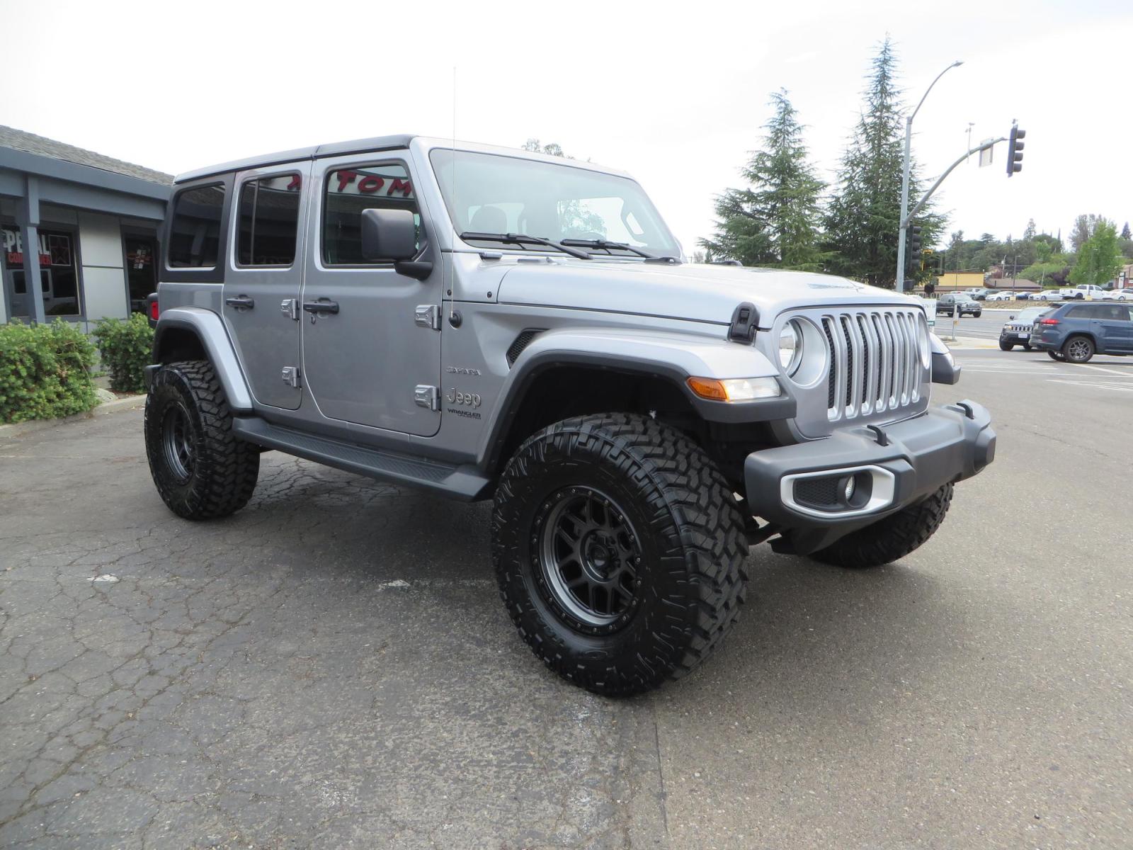 2020 Silver Jeep Wrangler Unlimited Sahara Sport Utility 4D (1C4HJXEN5LW) with an 4-Cyl eTorque Turbo 2.0 Liter engine, Automatic 8-Spd transmission, located at 2630 Grass Valley Highway, Auburn, CA, 95603, (530) 508-5100, 38.937893, -121.095482 - 3" Zone offroad lift kit, 17" KMC 544 wheels wrapped in Nitto Trail Grappler tires. - Photo #2