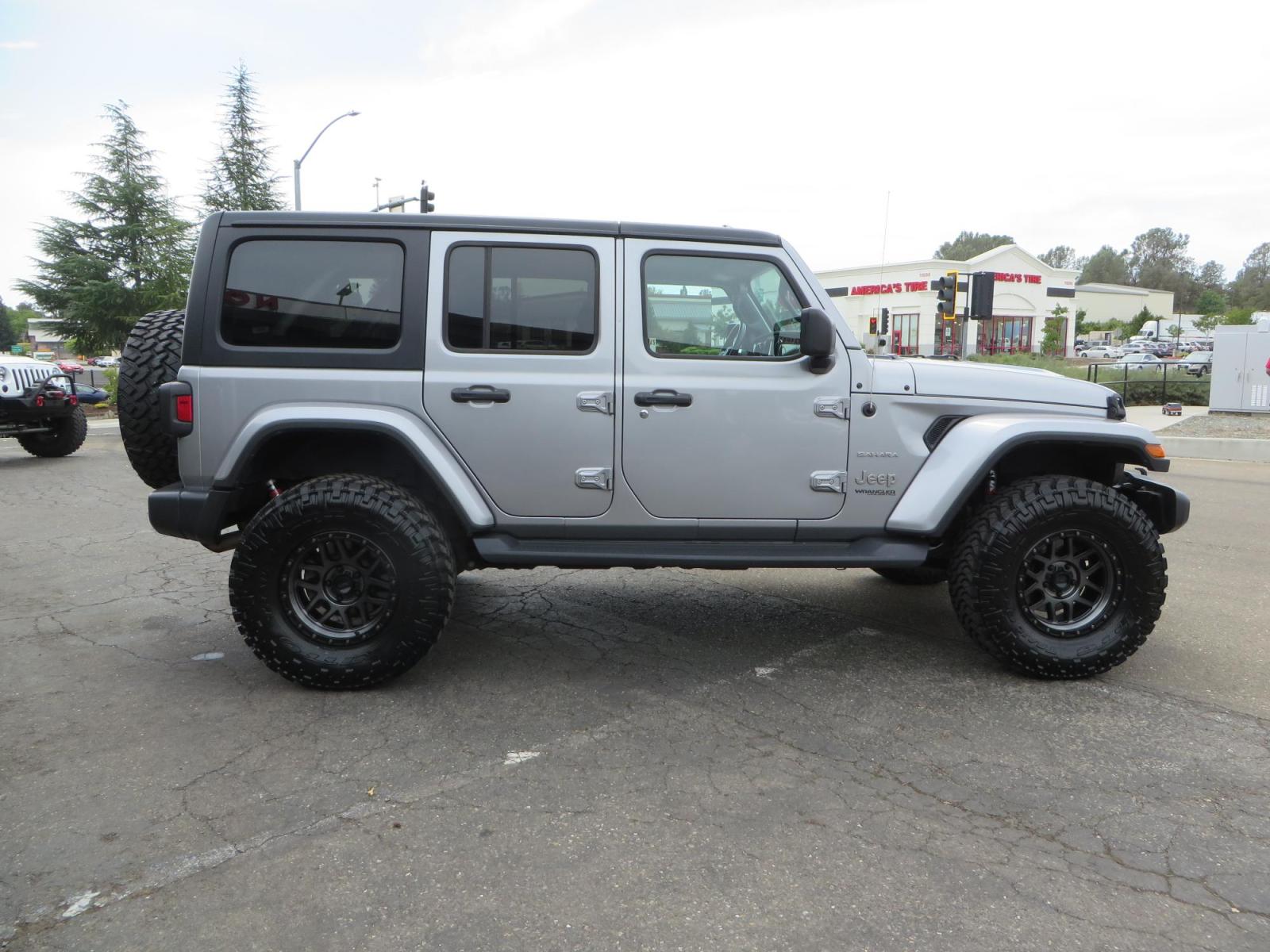 2020 Silver Jeep Wrangler Unlimited Sahara Sport Utility 4D (1C4HJXEN5LW) with an 4-Cyl eTorque Turbo 2.0 Liter engine, Automatic 8-Spd transmission, located at 2630 Grass Valley Highway, Auburn, CA, 95603, (530) 508-5100, 38.937893, -121.095482 - 3" Zone offroad lift kit, 17" KMC 544 wheels wrapped in Nitto Trail Grappler tires. - Photo #3