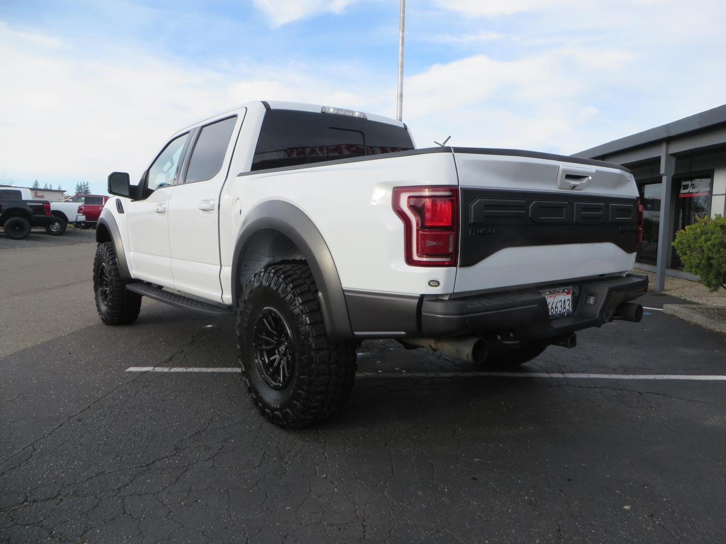 2020 White Ford F150 SuperCrew Cab Raptor Pickup 4D 5 1/2 ft (1FTFW1RG9LF) with an V6 EcoBoost High Output Twin Turbo 3.5 Liter engine, Automatic 10-Spd w/Sport Mode transmission, located at 2630 Grass Valley Highway, Auburn, CA, 95603, (530) 508-5100, 38.937893, -121.095482 - Features 17'' Fuel Rebel wheels, 37'' Goodyear Wrangler Boulder MT tires, Bakflip Tonneau cover, Lightbar behind the grille, Fog pocket led's, Cobb exhaust and cold air intake. - Photo#2