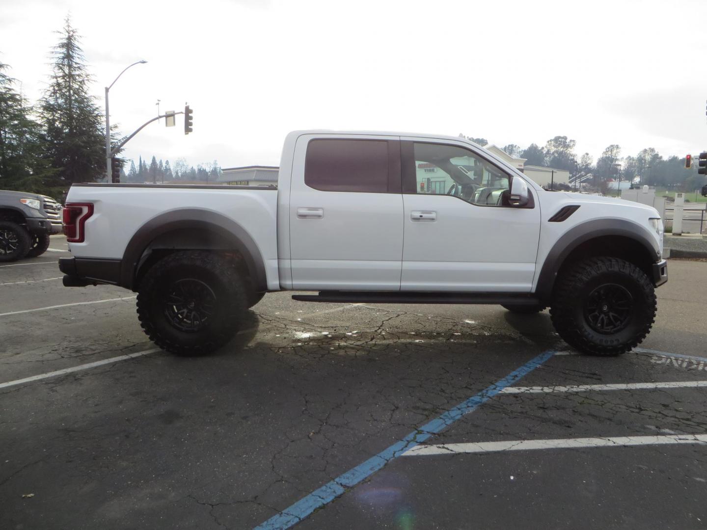 2020 White Ford F150 SuperCrew Cab Raptor Pickup 4D 5 1/2 ft (1FTFW1RG9LF) with an V6 EcoBoost High Output Twin Turbo 3.5 Liter engine, Automatic 10-Spd w/Sport Mode transmission, located at 2630 Grass Valley Highway, Auburn, CA, 95603, (530) 508-5100, 38.937893, -121.095482 - Features 17'' Fuel Rebel wheels, 37'' Goodyear Wrangler Boulder MT tires, Bakflip Tonneau cover, Lightbar behind the grille, Fog pocket led's, Cobb exhaust and cold air intake. - Photo#5