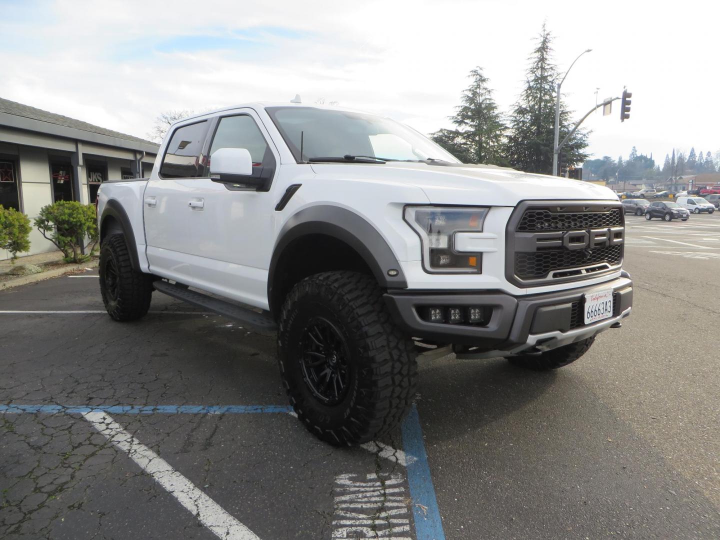 2020 White Ford F150 SuperCrew Cab Raptor Pickup 4D 5 1/2 ft (1FTFW1RG9LF) with an V6 EcoBoost High Output Twin Turbo 3.5 Liter engine, Automatic 10-Spd w/Sport Mode transmission, located at 2630 Grass Valley Highway, Auburn, CA, 95603, (530) 508-5100, 38.937893, -121.095482 - Features 17'' Fuel Rebel wheels, 37'' Goodyear Wrangler Boulder MT tires, Bakflip Tonneau cover, Lightbar behind the grille, Fog pocket led's, Cobb exhaust and cold air intake. - Photo#6