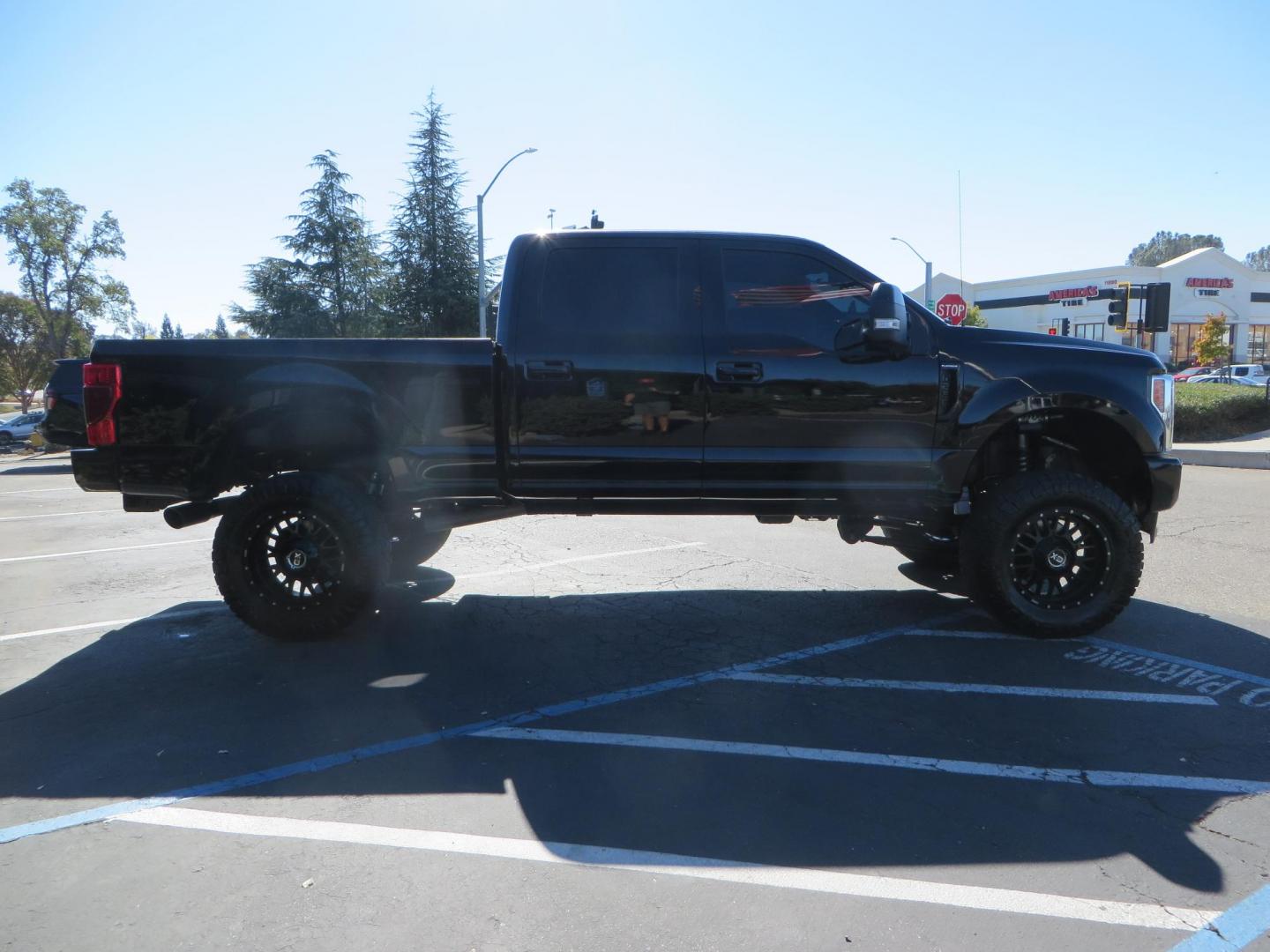 2017 BLACK Ford F-250 SD Platinum Crew Cab Short Bed 4WD (1FT7W2BT0HE) with an 6.7L V8 OHV 16V DIESEL engine, 6A transmission, located at 2630 Grass Valley Highway, Auburn, CA, 95603, (530) 508-5100, 38.937893, -121.095482 - Lifted F-250 featuring a SkyJacker long arm suspension system, Fox 2.5 remote reservoir coilovers, Fox 2.0 rear remote reservoir shocks, Fox dual steering stabilizers, 20" XD wheels, 37" Nitto Ridge Grappler tires, Racer X Mesh Grille, Airlift Air Bags, Painted badges, and window tint. - Photo#3