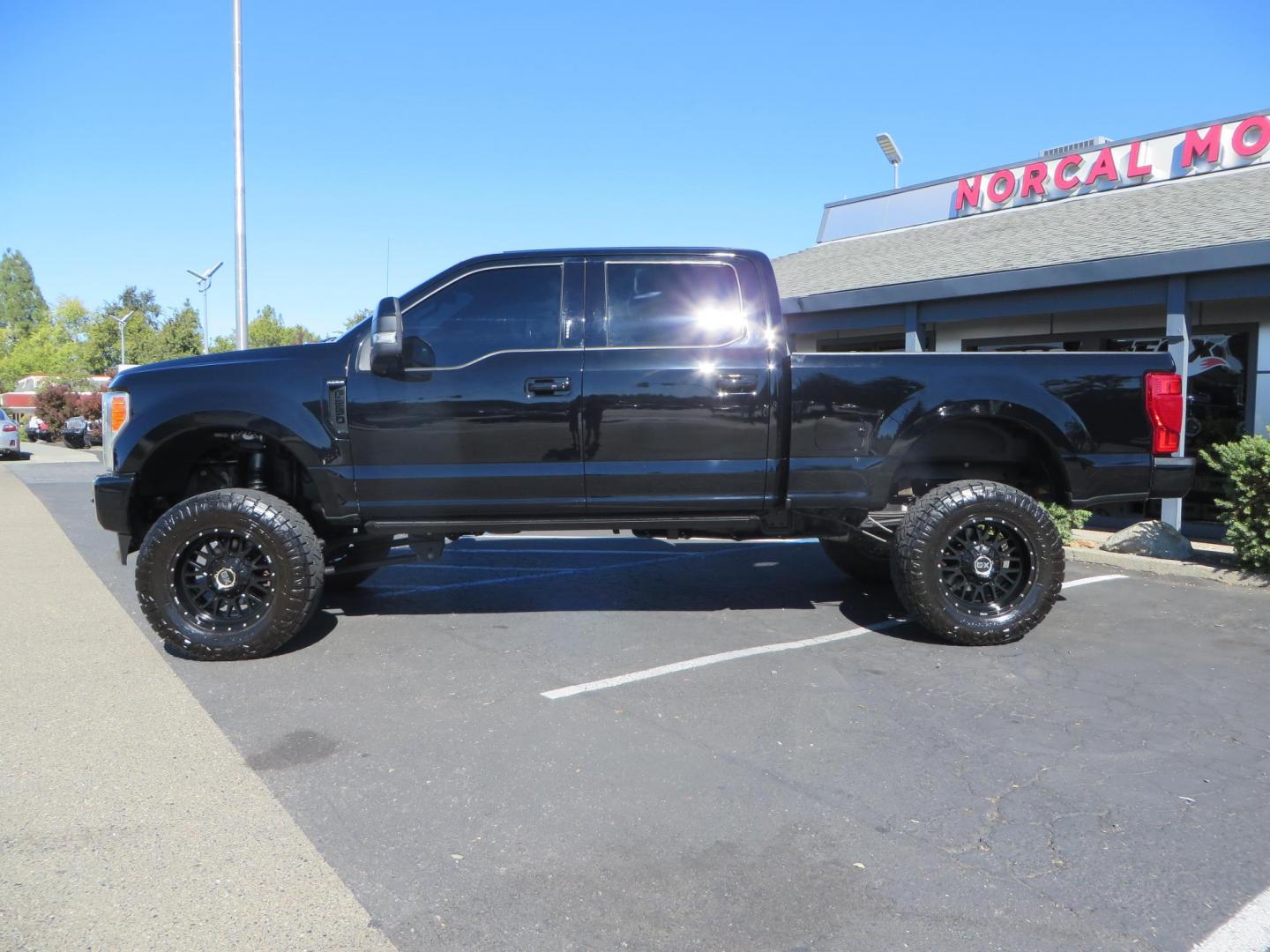 2017 BLACK Ford F-250 SD Platinum Crew Cab Short Bed 4WD (1FT7W2BT0HE) with an 6.7L V8 OHV 16V DIESEL engine, 6A transmission, located at 2630 Grass Valley Highway, Auburn, CA, 95603, (530) 508-5100, 38.937893, -121.095482 - Lifted F-250 featuring a SkyJacker long arm suspension system, Fox 2.5 remote reservoir coilovers, Fox 2.0 rear remote reservoir shocks, Fox dual steering stabilizers, 20" XD wheels, 37" Nitto Ridge Grappler tires, Racer X Mesh Grille, Airlift Air Bags, Painted badges, and window tint. - Photo#7