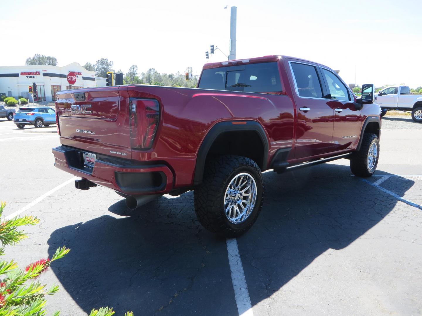 2024 Volcanic Red /Black GMC Sierra 2500HD Denali Crew Cab 4WD SB (1GT49REY6RF) with an 6.6L V8 OHV 16V TURBO DIESEL engine, 6A transmission, located at 2630 Grass Valley Highway, Auburn, CA, 95603, (530) 508-5100, 38.937893, -121.095482 - Denali 2500 featuring a Cognito Level kit, Fox shocks, 20" Fittipaldi FA18 wheels, 35" Nitto Ridge Grappler tires, and a LineX folding tonneau cover. - Photo#4