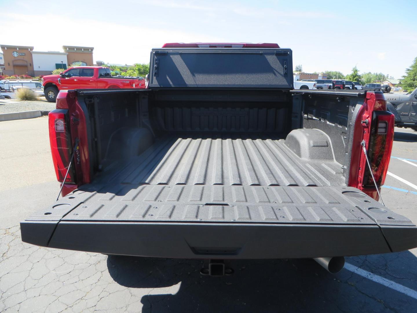2024 Volcanic Red /Black GMC Sierra 2500HD Denali Crew Cab 4WD SB (1GT49REY6RF) with an 6.6L V8 OHV 16V TURBO DIESEL engine, 6A transmission, located at 2630 Grass Valley Highway, Auburn, CA, 95603, (530) 508-5100, 38.937893, -121.095482 - Denali 2500 featuring a Cognito Level kit, Fox shocks, 20" Fittipaldi FA18 wheels, 35" Nitto Ridge Grappler tires, and a LineX folding tonneau cover. - Photo#21