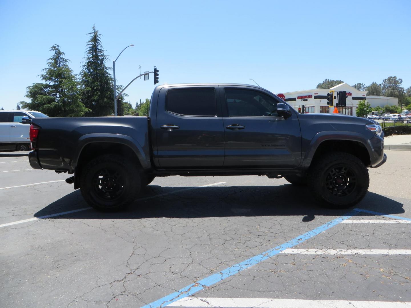 2018 CHARCOAL Toyota Tacoma TRD Sport Double Cab V6 6AT 4WD (3TMCZ5AN1JM) with an 3.6L V6 DOHC 24V engine, 6A transmission, located at 2630 Grass Valley Highway, Auburn, CA, 95603, (530) 508-5100, 38.937893, -121.095482 - Features a level kit, Nitto Terra Grappler G3 tires, TRD exhaust, and window tint. - Photo#3