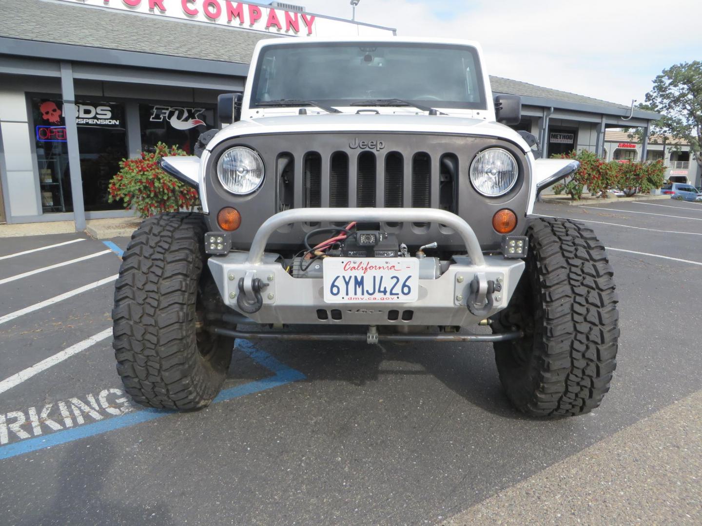2013 White Jeep Wrangler Rubicon 4WD (1C4BJWCGXDL) with an 3.6L V6 DOHC 24V FFV engine, located at 2630 Grass Valley Highway, Auburn, CA, 95603, (530) 508-5100, 38.937893, -121.095482 - Features a Metal Cloak suspension system, Old Man EMU shocks, Ruff Stuff differential covers, Synergy steering upgrade, 37" Mickey Thompson Baja Boss tires, 17" Steel wheels, Genright front bumper, Badland Winch, LED lights, Rear Bumper, Teraflex Ice Chest rack, HIgh LIft Jack, Jerry Can mount, D Ri - Photo#1