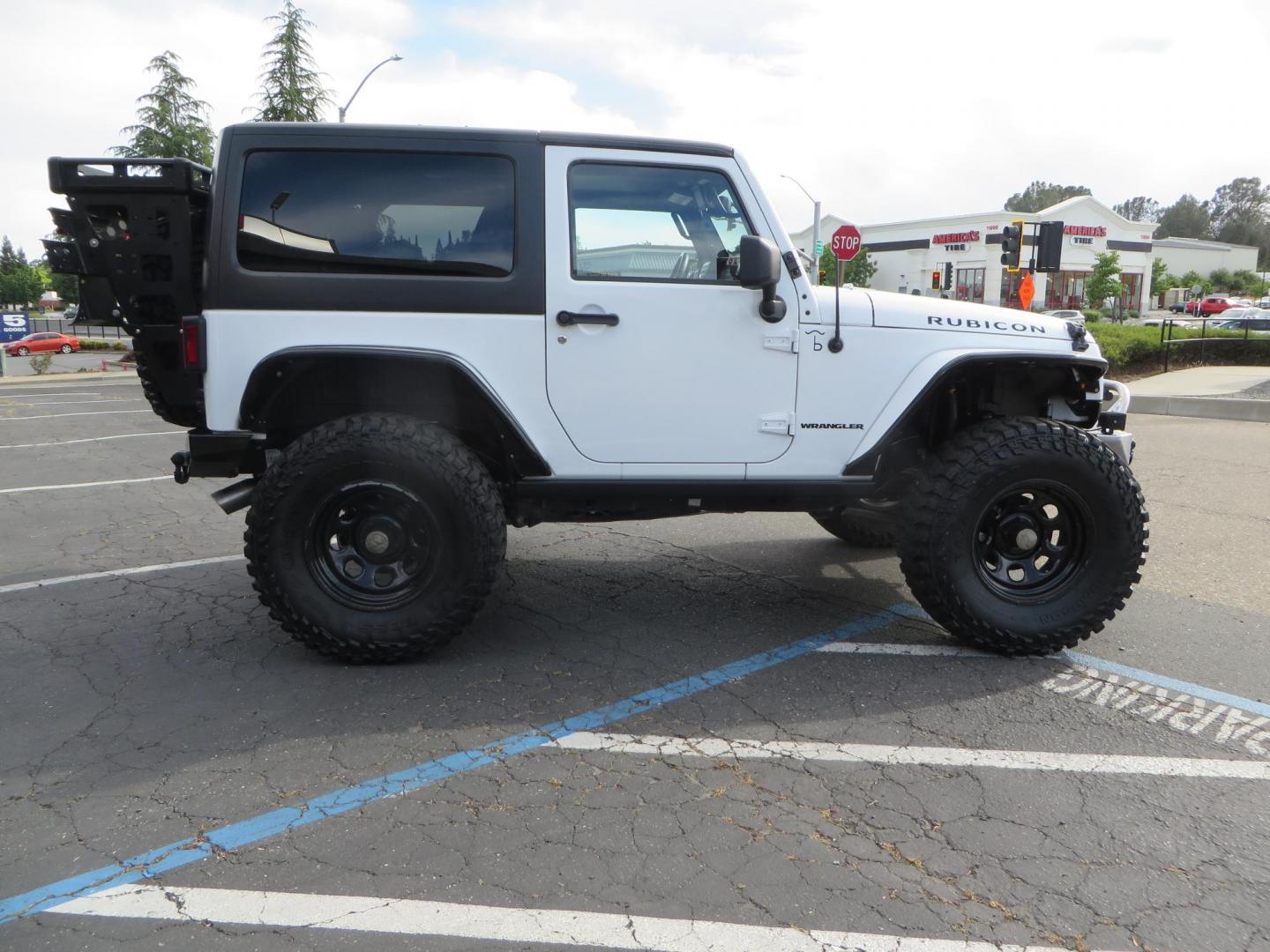 2013 White Jeep Wrangler Rubicon 4WD (1C4BJWCGXDL) with an 3.6L V6 DOHC 24V FFV engine, located at 2630 Grass Valley Highway, Auburn, CA, 95603, (530) 508-5100, 38.937893, -121.095482 - Features a Metal Cloak suspension system, Old Man EMU shocks, Ruff Stuff differential covers, Synergy steering upgrade, 37" Mickey Thompson Baja Boss tires, 17" Steel wheels, Genright front bumper, Badland Winch, LED lights, Rear Bumper, Teraflex Ice Chest rack, HIgh LIft Jack, Jerry Can mount, D Ri - Photo#3