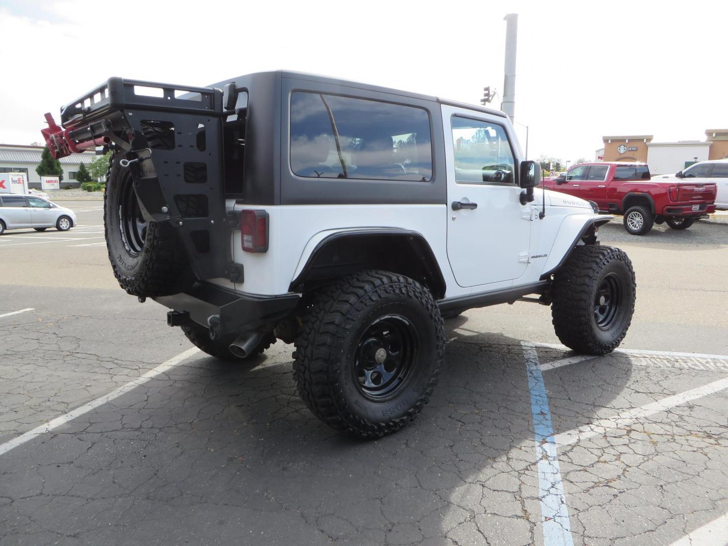 2013 White Jeep Wrangler Rubicon 4WD (1C4BJWCGXDL) with an 3.6L V6 DOHC 24V FFV engine, located at 2630 Grass Valley Highway, Auburn, CA, 95603, (530) 508-5100, 38.937893, -121.095482 - Features a Metal Cloak suspension system, Old Man EMU shocks, Ruff Stuff differential covers, Synergy steering upgrade, 37" Mickey Thompson Baja Boss tires, 17" Steel wheels, Genright front bumper, Badland Winch, LED lights, Rear Bumper, Teraflex Ice Chest rack, HIgh LIft Jack, Jerry Can mount, D Ri - Photo#4