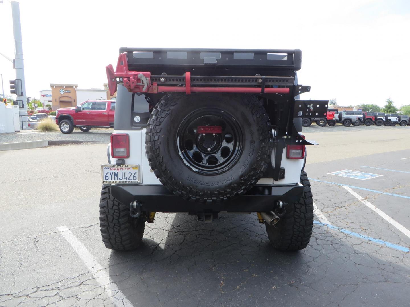 2013 White Jeep Wrangler Rubicon 4WD (1C4BJWCGXDL) with an 3.6L V6 DOHC 24V FFV engine, located at 2630 Grass Valley Highway, Auburn, CA, 95603, (530) 508-5100, 38.937893, -121.095482 - Features a Metal Cloak suspension system, Old Man EMU shocks, Ruff Stuff differential covers, Synergy steering upgrade, 37" Mickey Thompson Baja Boss tires, 17" Steel wheels, Genright front bumper, Badland Winch, LED lights, Rear Bumper, Teraflex Ice Chest rack, HIgh LIft Jack, Jerry Can mount, D Ri - Photo#5