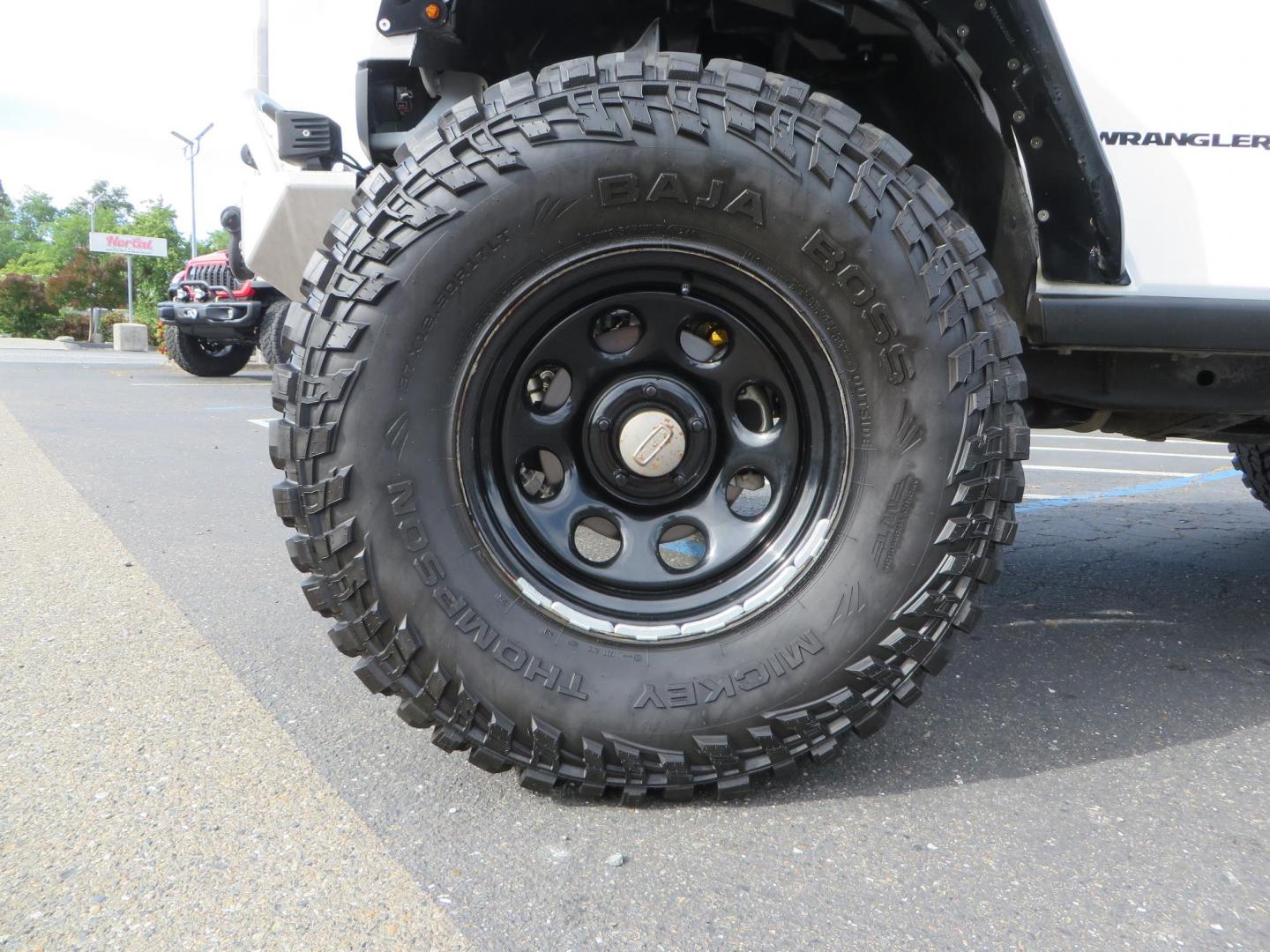 2013 White Jeep Wrangler Rubicon 4WD (1C4BJWCGXDL) with an 3.6L V6 DOHC 24V FFV engine, located at 2630 Grass Valley Highway, Auburn, CA, 95603, (530) 508-5100, 38.937893, -121.095482 - Features a Metal Cloak suspension system, Old Man EMU shocks, Ruff Stuff differential covers, Synergy steering upgrade, 37" Mickey Thompson Baja Boss tires, 17" Steel wheels, Genright front bumper, Badland Winch, LED lights, Rear Bumper, Teraflex Ice Chest rack, HIgh LIft Jack, Jerry Can mount, D Ri - Photo#7