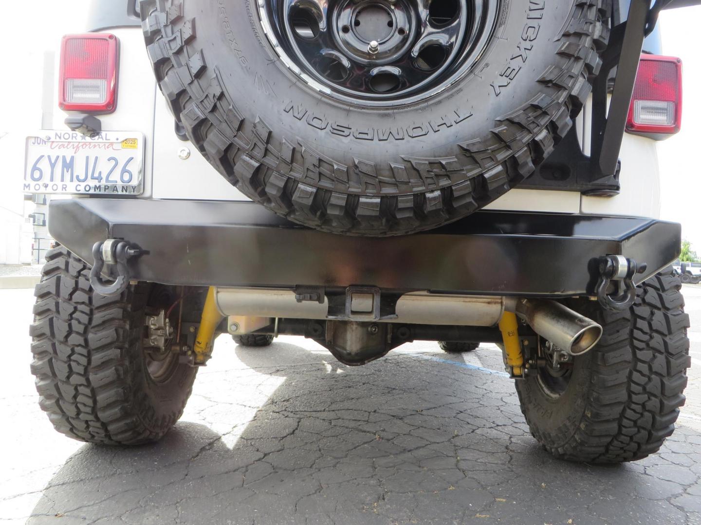 2013 White Jeep Wrangler Rubicon 4WD (1C4BJWCGXDL) with an 3.6L V6 DOHC 24V FFV engine, located at 2630 Grass Valley Highway, Auburn, CA, 95603, (530) 508-5100, 38.937893, -121.095482 - Features a Metal Cloak suspension system, Old Man EMU shocks, Ruff Stuff differential covers, Synergy steering upgrade, 37" Mickey Thompson Baja Boss tires, 17" Steel wheels, Genright front bumper, Badland Winch, LED lights, Rear Bumper, Teraflex Ice Chest rack, HIgh LIft Jack, Jerry Can mount, D Ri - Photo#18