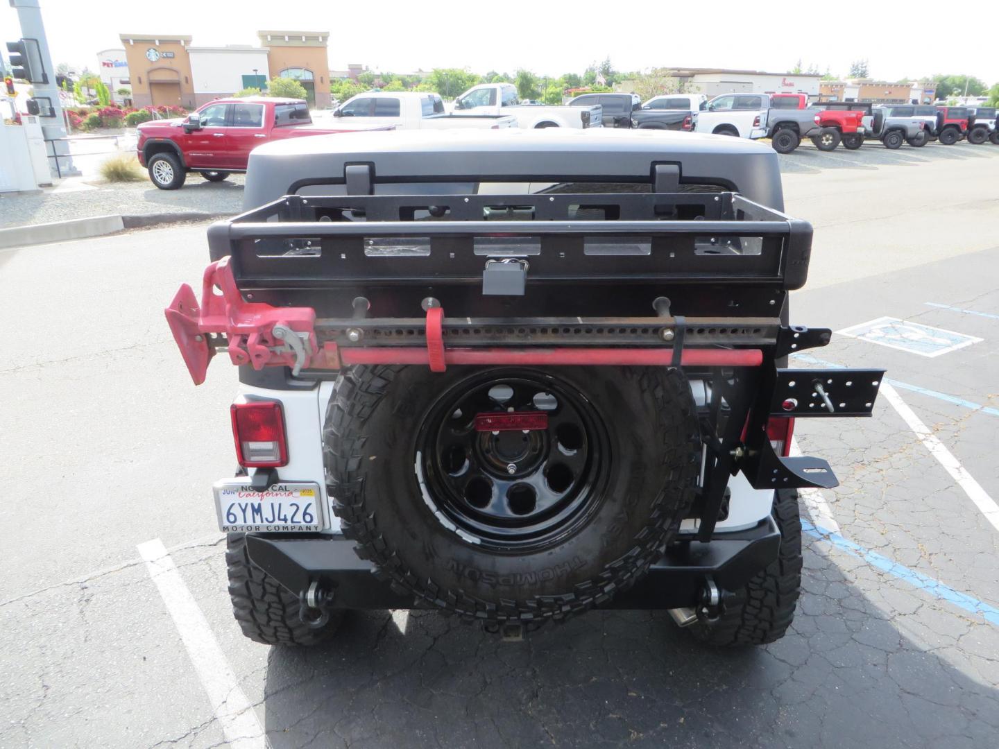 2013 White Jeep Wrangler Rubicon 4WD (1C4BJWCGXDL) with an 3.6L V6 DOHC 24V FFV engine, located at 2630 Grass Valley Highway, Auburn, CA, 95603, (530) 508-5100, 38.937893, -121.095482 - Features a Metal Cloak suspension system, Old Man EMU shocks, Ruff Stuff differential covers, Synergy steering upgrade, 37" Mickey Thompson Baja Boss tires, 17" Steel wheels, Genright front bumper, Badland Winch, LED lights, Rear Bumper, Teraflex Ice Chest rack, HIgh LIft Jack, Jerry Can mount, D Ri - Photo#19