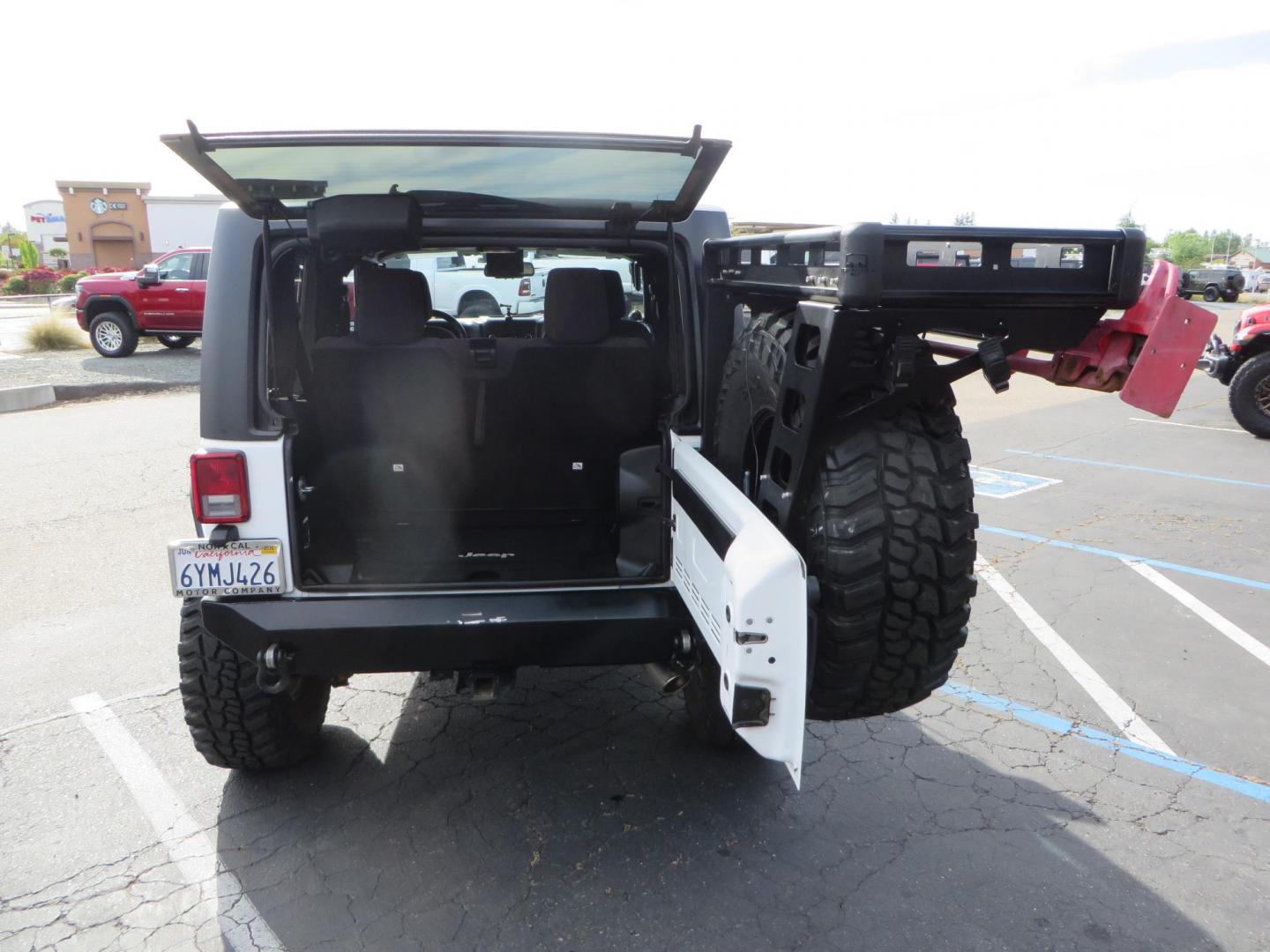 2013 White Jeep Wrangler Rubicon 4WD (1C4BJWCGXDL) with an 3.6L V6 DOHC 24V FFV engine, located at 2630 Grass Valley Highway, Auburn, CA, 95603, (530) 508-5100, 38.937893, -121.095482 - Features a Metal Cloak suspension system, Old Man EMU shocks, Ruff Stuff differential covers, Synergy steering upgrade, 37" Mickey Thompson Baja Boss tires, 17" Steel wheels, Genright front bumper, Badland Winch, LED lights, Rear Bumper, Teraflex Ice Chest rack, HIgh LIft Jack, Jerry Can mount, D Ri - Photo#54