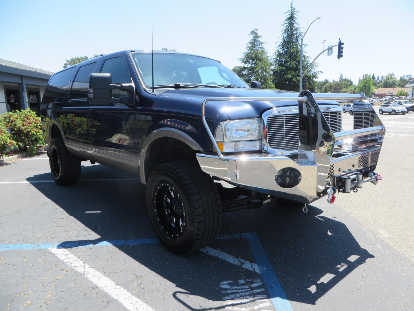 2003 Blue Ford Excursion Eddie Bauer 6.0L 4WD (1FMSU45PX3E) with an 6.0L V8 OHV 32V TURBO DIESEL engine, 5-Speed Automatic Overdrive transmission, located at 2630 Grass Valley Highway, Auburn, CA, 95603, (530) 508-5100, 38.937893, -121.095482 - Rare to find an Excursion especially like this... Extremely Clean 6.0L with ARP head studs, aluminum radiator, Lifted, Fuel wheels, Open Range AT tires, Bilstein Shocks, Amp power steps, Custom front and rear bumpers, 15K Warn Winch, Piaa Lights, RV Towable, Brake Controller, Edge Tuner CA legal, Ex - Photo#2