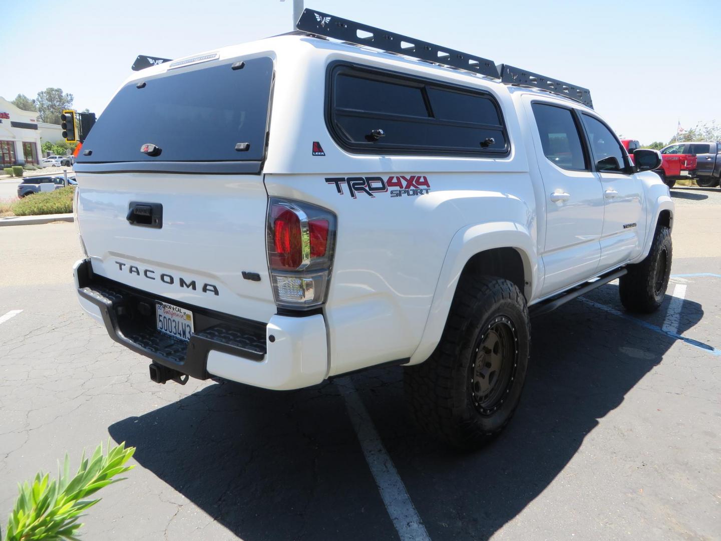 2021 White Toyota Tacoma SR5 Double Cab V6 6AT 4WD (3TMCZ5AN1MM) with an 3.5L V6 DOHC 24V engine, 6A transmission, located at 2630 Grass Valley Highway, Auburn, CA, 95603, (530) 508-5100, 38.937893, -121.095482 - Icon Vehicle Dynamics remote reservoir coilovers & shocks, Icon Upper control arms, 1552 wheels, Toyo AT3 tires, Rock Sliders, Victory 4x4 roof and camper shell rack, Leer Camper shell, Banks Idash. - Photo#7