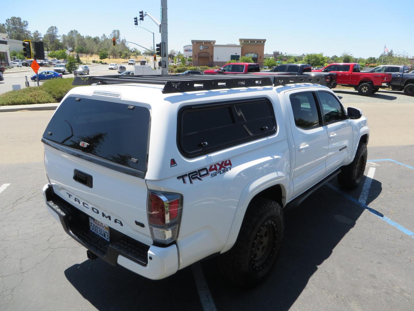 2021 White Toyota Tacoma SR5 Double Cab V6 6AT 4WD (3TMCZ5AN1MM) with an 3.5L V6 DOHC 24V engine, 6A transmission, located at 2630 Grass Valley Highway, Auburn, CA, 95603, (530) 508-5100, 38.937893, -121.095482 - Icon Vehicle Dynamics remote reservoir coilovers & shocks, Icon Upper control arms, 1552 wheels, Toyo AT3 tires, Rock Sliders, Victory 4x4 roof and camper shell rack, Leer Camper shell, Banks Idash. - Photo#8