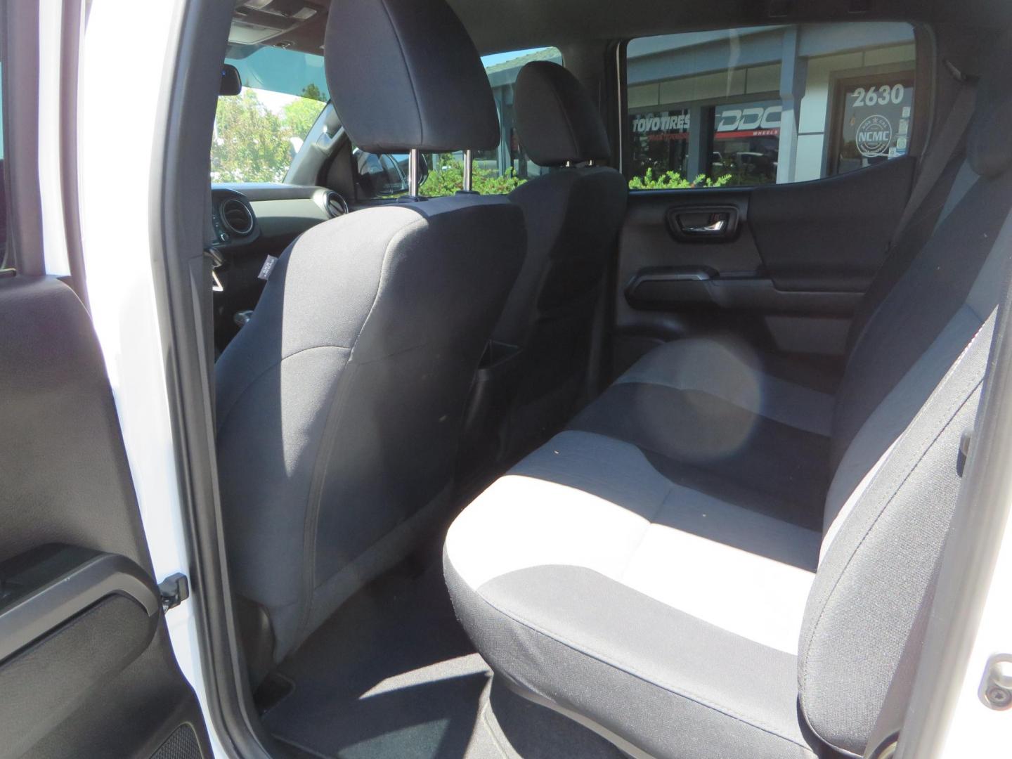 2021 White Toyota Tacoma SR5 Double Cab V6 6AT 4WD (3TMCZ5AN1MM) with an 3.5L V6 DOHC 24V engine, 6A transmission, located at 2630 Grass Valley Highway, Auburn, CA, 95603, (530) 508-5100, 38.937893, -121.095482 - Icon Vehicle Dynamics remote reservoir coilovers & shocks, Icon Upper control arms, 1552 wheels, Toyo AT3 tires, Rock Sliders, Victory 4x4 roof and camper shell rack, Leer Camper shell, Banks Idash. - Photo#49