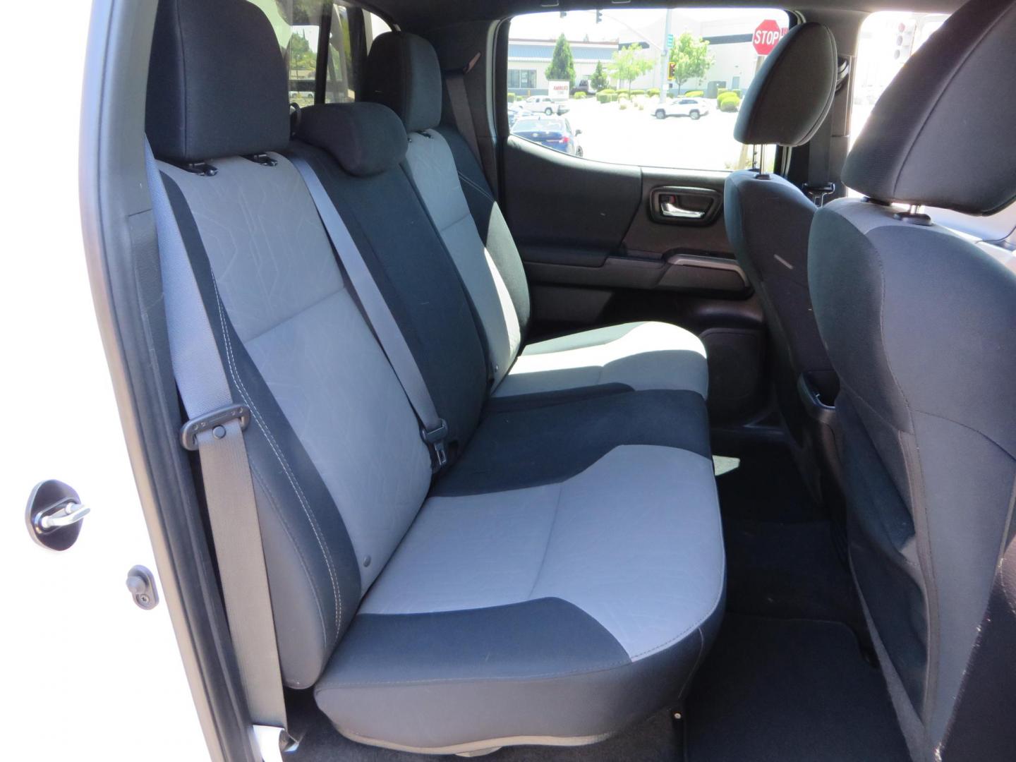 2021 White Toyota Tacoma SR5 Double Cab V6 6AT 4WD (3TMCZ5AN1MM) with an 3.5L V6 DOHC 24V engine, 6A transmission, located at 2630 Grass Valley Highway, Auburn, CA, 95603, (530) 508-5100, 38.937893, -121.095482 - Icon Vehicle Dynamics remote reservoir coilovers & shocks, Icon Upper control arms, 1552 wheels, Toyo AT3 tires, Rock Sliders, Victory 4x4 roof and camper shell rack, Leer Camper shell, Banks Idash. - Photo#53