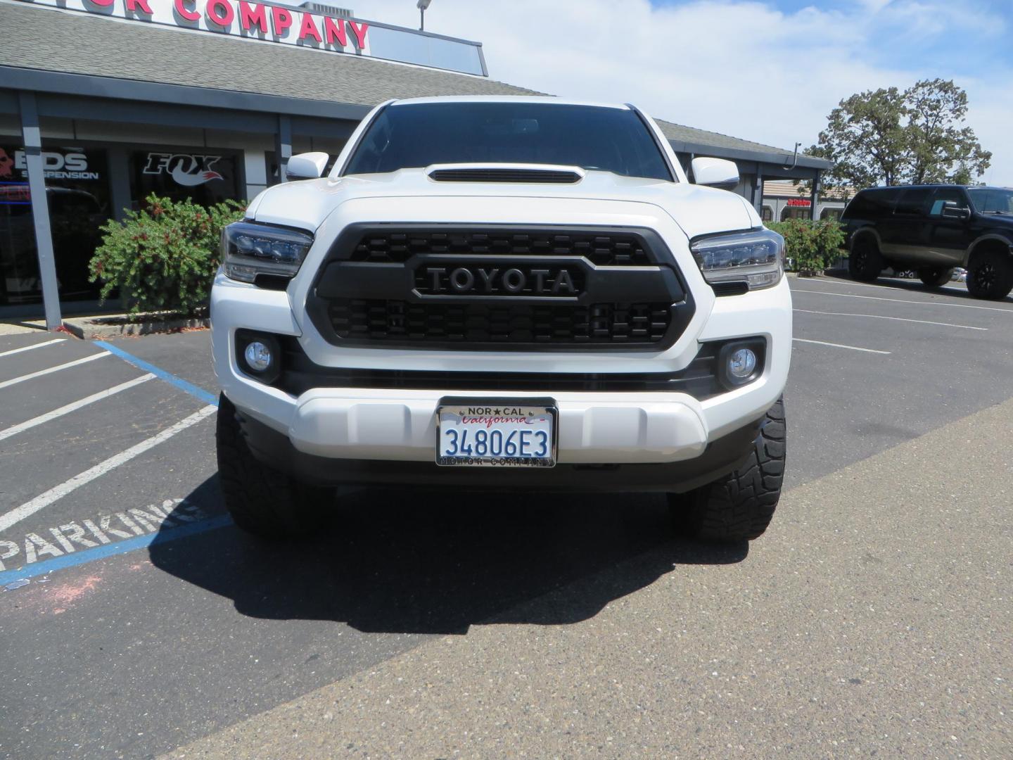 2021 White Toyota Tacoma SR5 Double Cab V6 6AT 4WD (3TYCZ5AN8MT) with an 3.5L V6 DOHC 24V engine, 6A transmission, located at 2630 Grass Valley Highway, Auburn, CA, 95603, (530) 508-5100, 38.937893, -121.095482 - Leveled Tacoma sitting on 18" Fuel wheels, Toyo RT tires, Bakflip bed cover, and window tint. - Photo#1