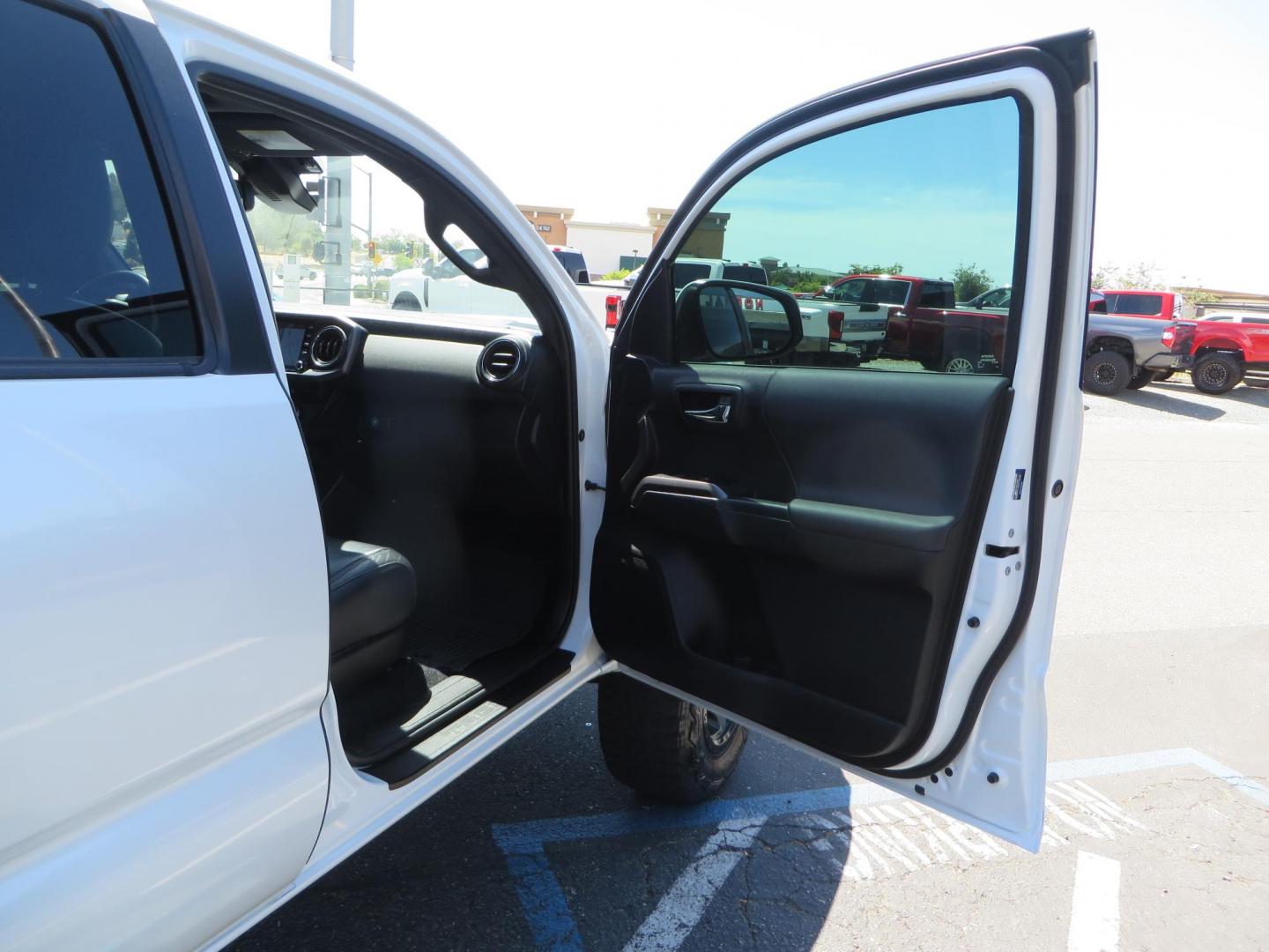 2021 White Toyota Tacoma SR5 Double Cab V6 6AT 4WD (3TYCZ5AN8MT) with an 3.5L V6 DOHC 24V engine, 6A transmission, located at 2630 Grass Valley Highway, Auburn, CA, 95603, (530) 508-5100, 38.937893, -121.095482 - Leveled Tacoma sitting on 18" Fuel wheels, Toyo RT tires, Bakflip bed cover, and window tint. - Photo#40
