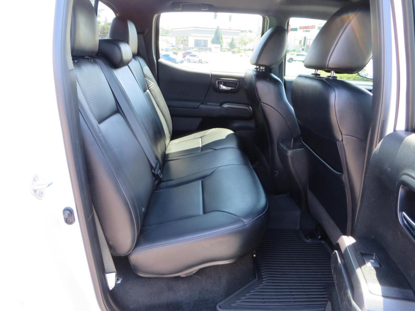 2021 White Toyota Tacoma SR5 Double Cab V6 6AT 4WD (3TYCZ5AN8MT) with an 3.5L V6 DOHC 24V engine, 6A transmission, located at 2630 Grass Valley Highway, Auburn, CA, 95603, (530) 508-5100, 38.937893, -121.095482 - Leveled Tacoma sitting on 18" Fuel wheels, Toyo RT tires, Bakflip bed cover, and window tint. - Photo#51