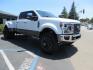 2021 White Ford F-450 SD King Ranch Crew Cab DRW 4WD (1FT8W4DT6ME) with an 6.7L V8 OHV 16V DIESEL engine, 6A transmission, located at 2630 Grass Valley Highway, Auburn, CA, 95603, (530) 508-5100, 38.937893, -121.095482 - Must see F450 King Ranch sitting on 37" Nitto Ridge Grappler tires wrapped around 22" American Force wheels, 2.5" King Remote reservoir Coilovers, King 2.5 adjustable shocks, King dual steering stabilizers, and window tint. - Photo#2
