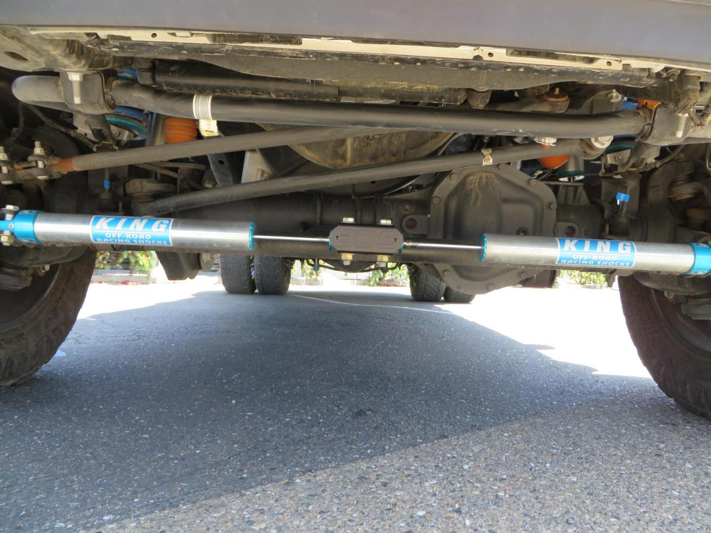 2021 White Ford F-450 SD King Ranch Crew Cab DRW 4WD (1FT8W4DT6ME) with an 6.7L V8 OHV 16V DIESEL engine, 6A transmission, located at 2630 Grass Valley Highway, Auburn, CA, 95603, (530) 508-5100, 38.937893, -121.095482 - Must see F450 King Ranch sitting on 37" Nitto Ridge Grappler tires wrapped around 22" American Force wheels, 2.5" King Remote reservoir Coilovers, King 2.5 adjustable shocks, King dual steering stabilizers, and window tint. - Photo#14