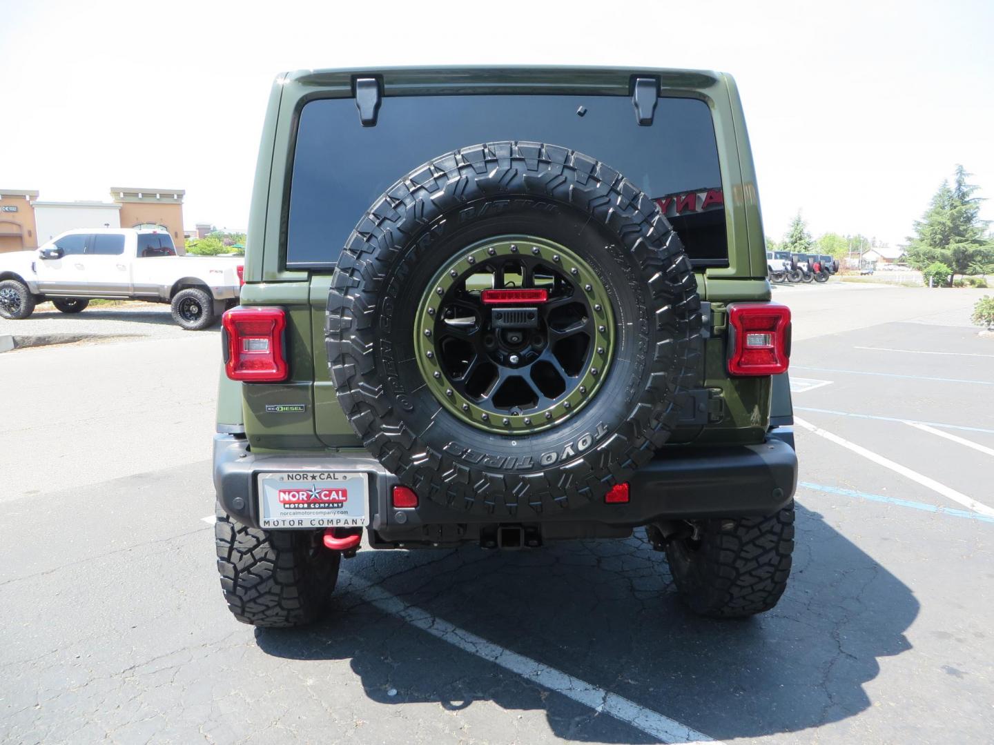 2021 Green Jeep Wrangler Unlimited Rubicon (1C4JJXFM1MW) with an 3.0L V6 DOHC 24V TURBO DIESEL engine, 6A transmission, located at 2630 Grass Valley Highway, Auburn, CA, 95603, (530) 508-5100, 38.937893, -121.095482 - Mopar lifted Diesel Rubicon with Fox shocks, HD tire carrier, Amp Power steps, Roof Rack, and color matched simulated beadlock rings. - Photo#3