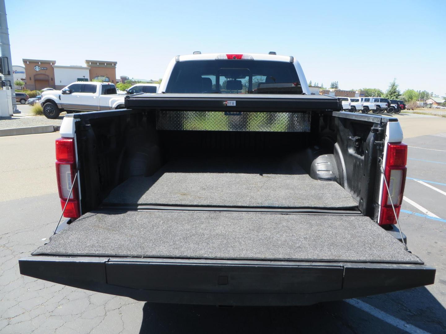 2022 White /BLACK Ford F-350 SD Platinum Crew Cab 4WD (1FT8W3BT2NE) with an 6.7L V8 OHV 16V DIESEL engine, 6A transmission, located at 2630 Grass Valley Highway, Auburn, CA, 95603, (530) 508-5100, 38.937893, -121.095482 - Features a BDS 2" level kit, Fox shocks, 18" Method MR323 wheels, 37" Toyo RT Pro tires, UWS tool box, folding bedcover. - Photo#12