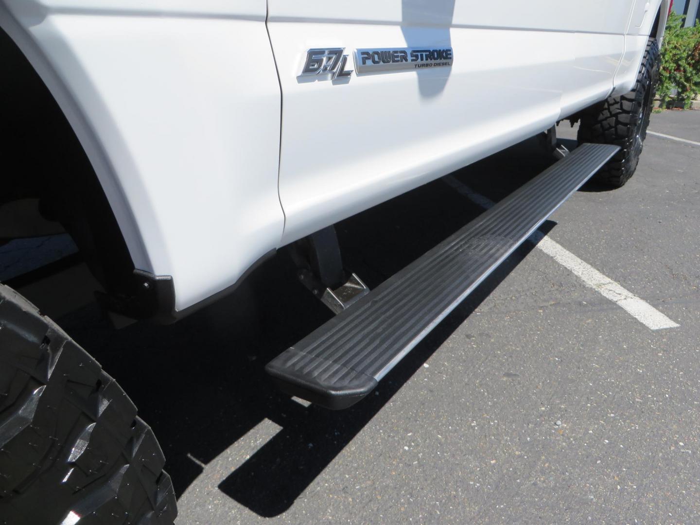 2022 White /BLACK Ford F-350 SD Platinum Crew Cab 4WD (1FT8W3BT2NE) with an 6.7L V8 OHV 16V DIESEL engine, 6A transmission, located at 2630 Grass Valley Highway, Auburn, CA, 95603, (530) 508-5100, 38.937893, -121.095482 - Features a BDS 2" level kit, Fox shocks, 18" Method MR323 wheels, 37" Toyo RT Pro tires, UWS tool box, folding bedcover. - Photo#15