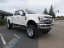 2019 White /Black Ford F-250 SD Lariat Crew Cab Short Bed 4WD (1FT7W2BT2KE) with an 6.7L V8 OHV 16V DIESEL engine, 6A transmission, located at 2630 Grass Valley Highway, Auburn, CA, 95603, (530) 508-5100, 38.937893, -121.095482 - Features a Fabtech 6" 4 link Lift kit, Fox remote reservoir shocks, 37" RBP MT tires, 22" Hostile wheels, Bushwacker Fender flares, Undercover Ultraflex bedcover, and window tint. - Photo#6