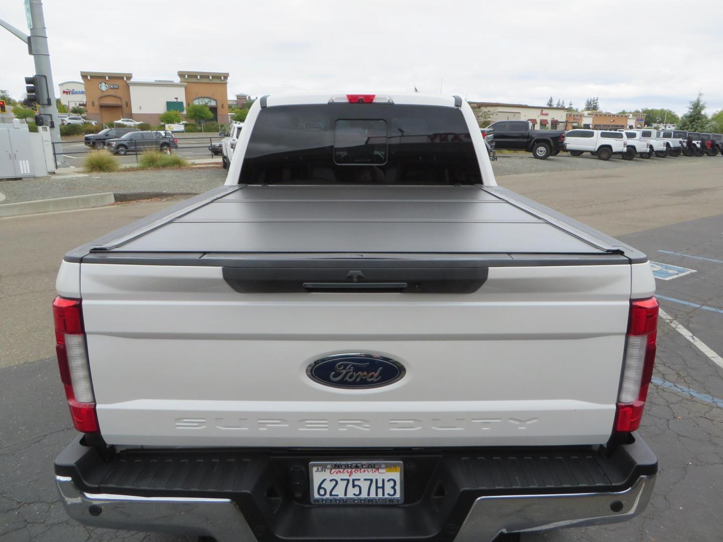 2019 White /Black Ford F-250 SD Lariat Crew Cab Short Bed 4WD (1FT7W2BT2KE) with an 6.7L V8 OHV 16V DIESEL engine, 6A transmission, located at 2630 Grass Valley Highway, Auburn, CA, 95603, (530) 508-5100, 38.937893, -121.095482 - Features a Fabtech 6" 4 link Lift kit, Fox remote reservoir shocks, 37" RBP MT tires, 22" Hostile wheels, Bushwacker Fender flares, Undercover Ultraflex bedcover, and window tint. - Photo#15