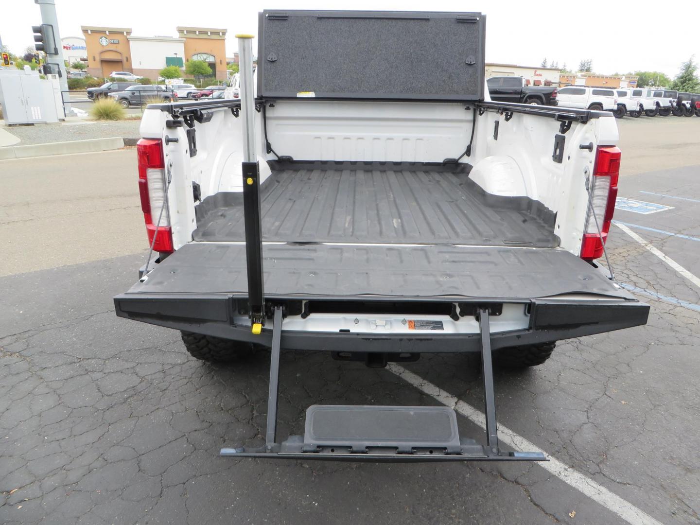 2019 White /Black Ford F-250 SD Lariat Crew Cab Short Bed 4WD (1FT7W2BT2KE) with an 6.7L V8 OHV 16V DIESEL engine, 6A transmission, located at 2630 Grass Valley Highway, Auburn, CA, 95603, (530) 508-5100, 38.937893, -121.095482 - Features a Fabtech 6" 4 link Lift kit, Fox remote reservoir shocks, 37" RBP MT tires, 22" Hostile wheels, Bushwacker Fender flares, Undercover Ultraflex bedcover, and window tint. - Photo#17