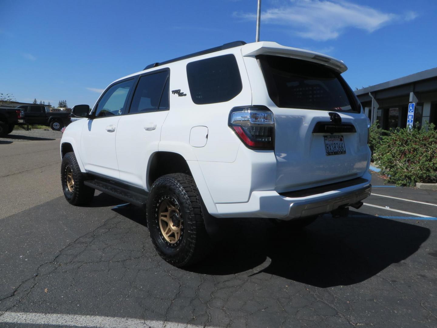 2021 White Toyota 4Runner TRD Off-road Premium 4WD (JTERU5JR5M5) with an 4.0L V6 DOHC 24V engine, 5A transmission, located at 2630 Grass Valley Highway, Auburn, CA, 95603, (530) 508-5100, 38.937893, -121.095482 - TRD Offroad Premium 4Runner ready for all of your adventures. Features Ironman suspension, 285 Falken Wildpeak AT3W tires, 17" Method Race wheels, Front winch bumper, Badlands winch, Led bumper and ditch lights, and rear cargo molle panels. - Photo#2