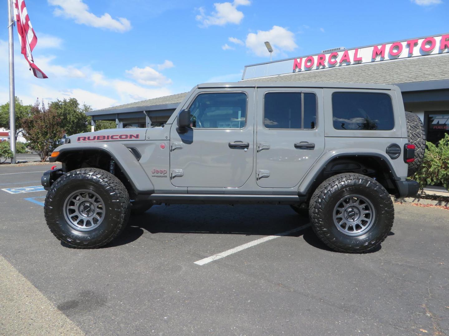 2021 Gray Jeep Wrangler Unlimited Rubicon (1C4HJXFN3MW) with an 2.0L L4 DOHC 16V TURBO engine, 6A transmission, located at 2630 Grass Valley Highway, Auburn, CA, 95603, (530) 508-5100, 38.937893, -121.095482 - Mopar lifted Rubicon, Fox shocks, 17" Method race wheels, 37" Nitto Recon Grappler tires, Falcon steering stabilizer, Smittybilt HD spare tire carrier, and Weathertech 1st and 2nd row floor liners. - Photo#1