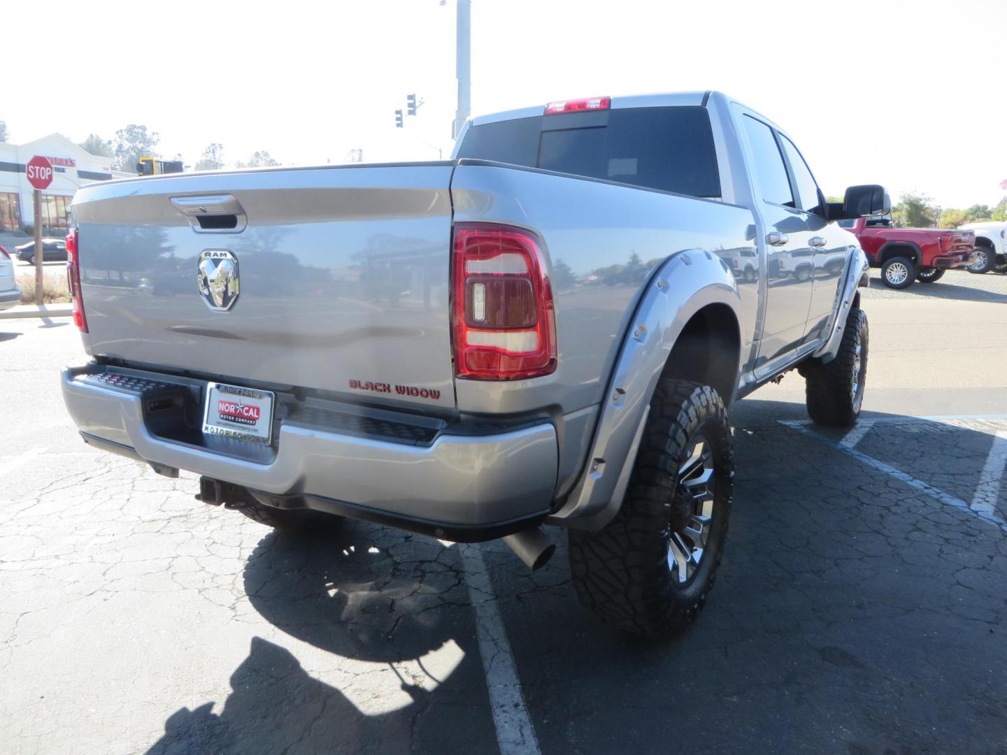 2022 SILVER /Black RAM 2500 Big Horn Black Widow Edition Crew Cab 4WD (3C6UR5DL3NG) with an 6.7L L6 OHV 24V TURBO DIESEL engine, 6A transmission, located at 2630 Grass Valley Highway, Auburn, CA, 95603, (530) 508-5100, 38.937893, -121.095482 - Ram 2500 Black Widow Edition Features 5" Suspension Lift System 20" Black Off Road Wheels 37" BFG KM3 Mud Terrain Tires Color Matched Pocket Fender Flares AMP Power Running Boards Tinted Front Windows Black Widow Gauge Cluster Black Widow Custom Stitched Headrests Red LED Interior Lights P - Photo#4