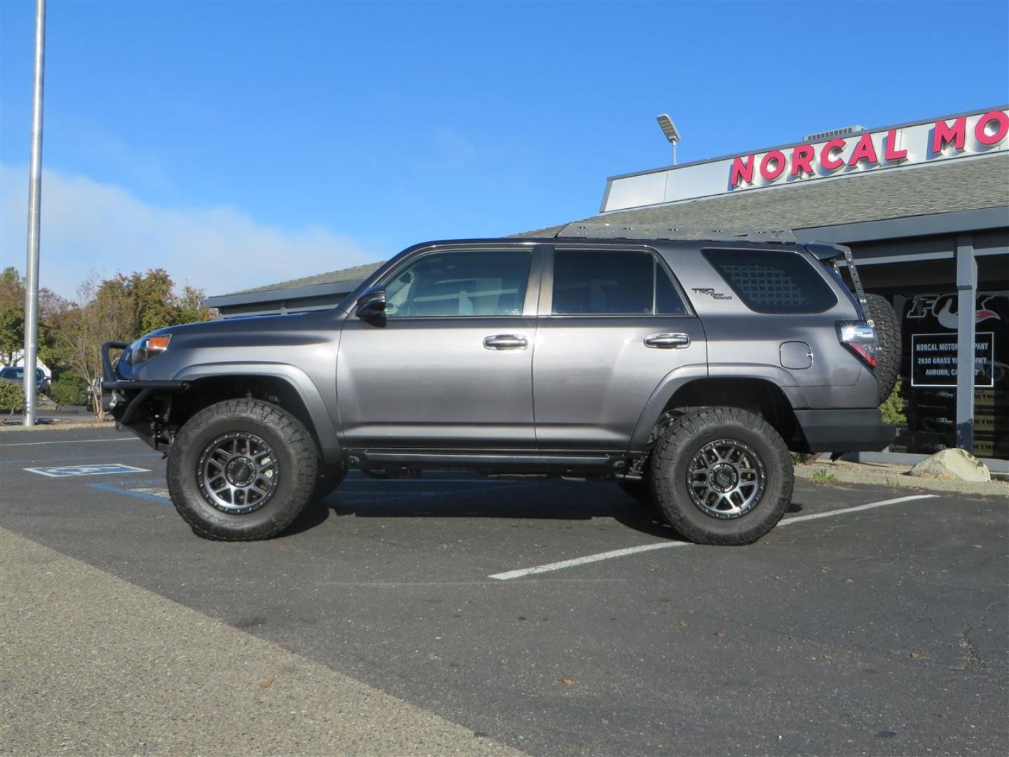 2021 grey /black Toyota 4Runner TRD Off-road Premium 4WD (JTERU5JR3M5) with an 4.0L V6 DOHC 24V engine, 5A transmission, located at 2630 Grass Valley Highway, Auburn, CA, 95603, (530) 508-5100, 38.937893, -121.095482 - Featuring Icon suspension, C4 front bumper, Victory 4x4 rear bumper with spare tire carrier, C4 ladder, Victory 4x4 roof rack, Victory 4x4 rock sliders, Baja designs LED's, 17'' KMC wheels, Maxxis Razr AT tires, and a Victory 4x4 rear cargo Molle panel. - Photo#1