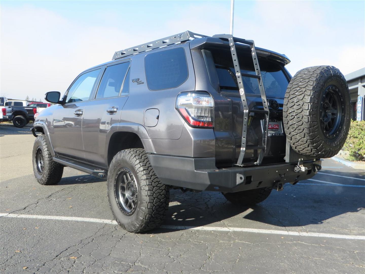 2021 grey /black Toyota 4Runner TRD Off-road Premium 4WD (JTERU5JR3M5) with an 4.0L V6 DOHC 24V engine, 5A transmission, located at 2630 Grass Valley Highway, Auburn, CA, 95603, (530) 508-5100, 38.937893, -121.095482 - Featuring Icon suspension, C4 front bumper, Victory 4x4 rear bumper with spare tire carrier, C4 ladder, Victory 4x4 roof rack, Victory 4x4 rock sliders, Baja designs LED's, 17'' KMC wheels, Maxxis Razr AT tires, and a Victory 4x4 rear cargo Molle panel. - Photo#2