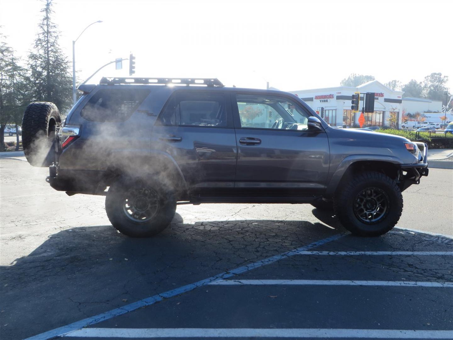 2021 grey /black Toyota 4Runner TRD Off-road Premium 4WD (JTERU5JR3M5) with an 4.0L V6 DOHC 24V engine, 5A transmission, located at 2630 Grass Valley Highway, Auburn, CA, 95603, (530) 508-5100, 38.937893, -121.095482 - Featuring Icon suspension, C4 front bumper, Victory 4x4 rear bumper with spare tire carrier, C4 ladder, Victory 4x4 roof rack, Victory 4x4 rock sliders, Baja designs LED's, 17'' KMC wheels, Maxxis Razr AT tires, and a Victory 4x4 rear cargo Molle panel. - Photo#5