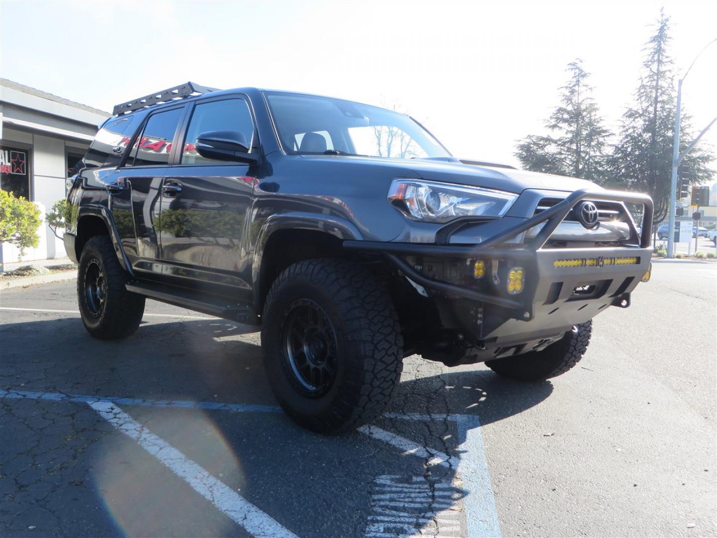 2021 grey /black Toyota 4Runner TRD Off-road Premium 4WD (JTERU5JR3M5) with an 4.0L V6 DOHC 24V engine, 5A transmission, located at 2630 Grass Valley Highway, Auburn, CA, 95603, (530) 508-5100, 38.937893, -121.095482 - Featuring Icon suspension, C4 front bumper, Victory 4x4 rear bumper with spare tire carrier, C4 ladder, Victory 4x4 roof rack, Victory 4x4 rock sliders, Baja designs LED's, 17'' KMC wheels, Maxxis Razr AT tires, and a Victory 4x4 rear cargo Molle panel. - Photo#6