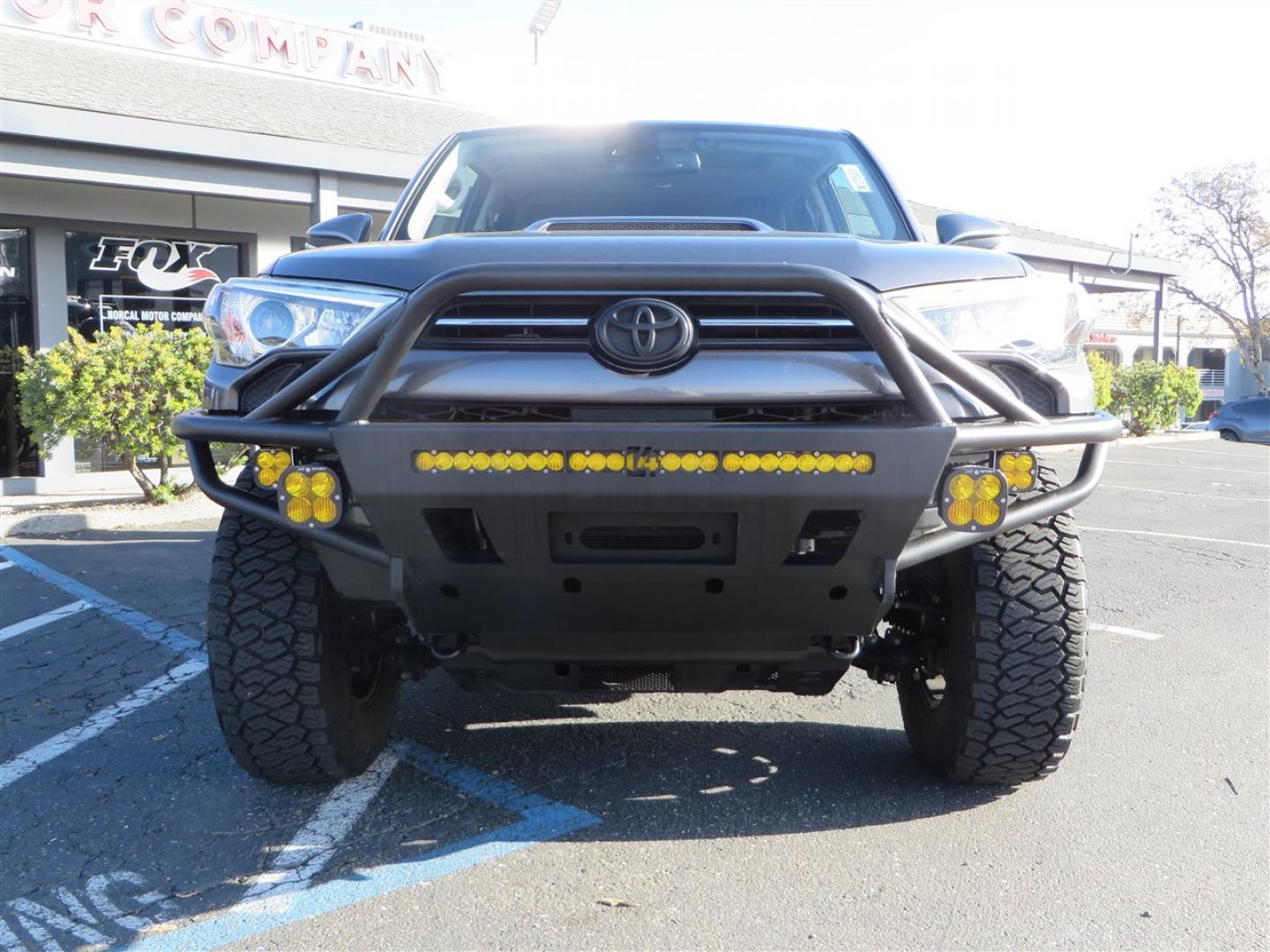 2021 grey /black Toyota 4Runner TRD Off-road Premium 4WD (JTERU5JR3M5) with an 4.0L V6 DOHC 24V engine, 5A transmission, located at 2630 Grass Valley Highway, Auburn, CA, 95603, (530) 508-5100, 38.937893, -121.095482 - Featuring Icon suspension, C4 front bumper, Victory 4x4 rear bumper with spare tire carrier, C4 ladder, Victory 4x4 roof rack, Victory 4x4 rock sliders, Baja designs LED's, 17'' KMC wheels, Maxxis Razr AT tires, and a Victory 4x4 rear cargo Molle panel. - Photo#7