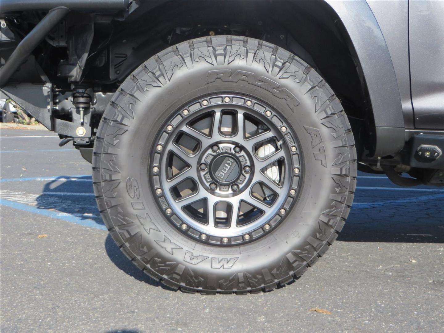 2021 grey /black Toyota 4Runner TRD Off-road Premium 4WD (JTERU5JR3M5) with an 4.0L V6 DOHC 24V engine, 5A transmission, located at 2630 Grass Valley Highway, Auburn, CA, 95603, (530) 508-5100, 38.937893, -121.095482 - Featuring Icon suspension, C4 front bumper, Victory 4x4 rear bumper with spare tire carrier, C4 ladder, Victory 4x4 roof rack, Victory 4x4 rock sliders, Baja designs LED's, 17'' KMC wheels, Maxxis Razr AT tires, and a Victory 4x4 rear cargo Molle panel. - Photo#8