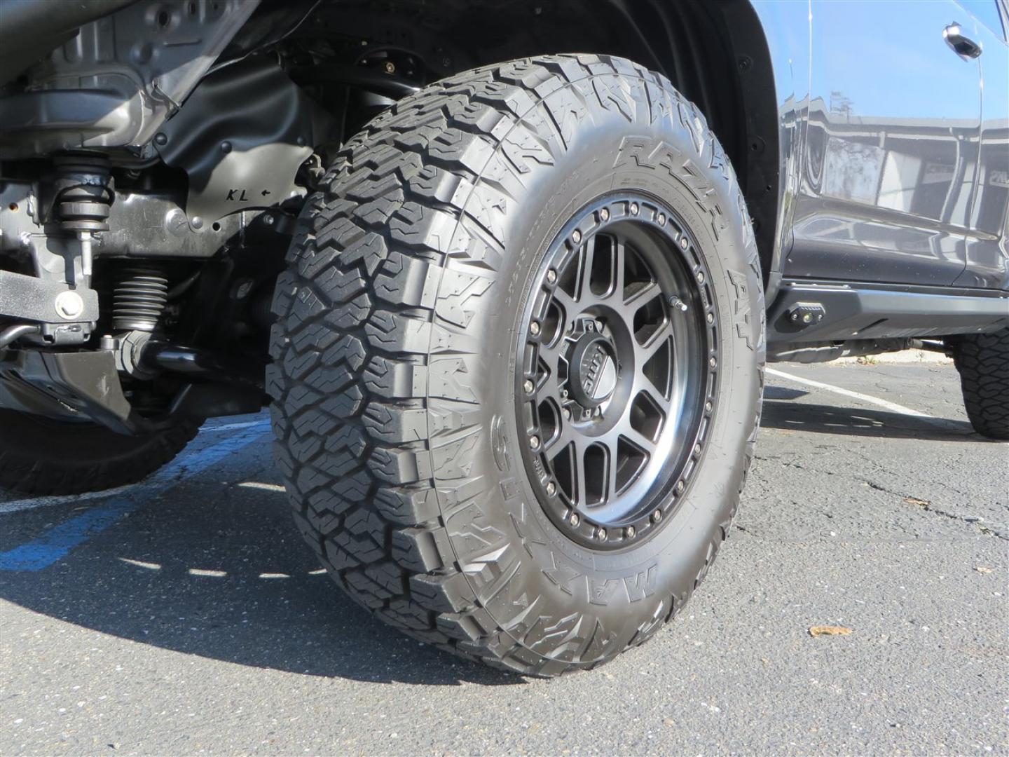 2021 grey /black Toyota 4Runner TRD Off-road Premium 4WD (JTERU5JR3M5) with an 4.0L V6 DOHC 24V engine, 5A transmission, located at 2630 Grass Valley Highway, Auburn, CA, 95603, (530) 508-5100, 38.937893, -121.095482 - Featuring Icon suspension, C4 front bumper, Victory 4x4 rear bumper with spare tire carrier, C4 ladder, Victory 4x4 roof rack, Victory 4x4 rock sliders, Baja designs LED's, 17'' KMC wheels, Maxxis Razr AT tires, and a Victory 4x4 rear cargo Molle panel. - Photo#9