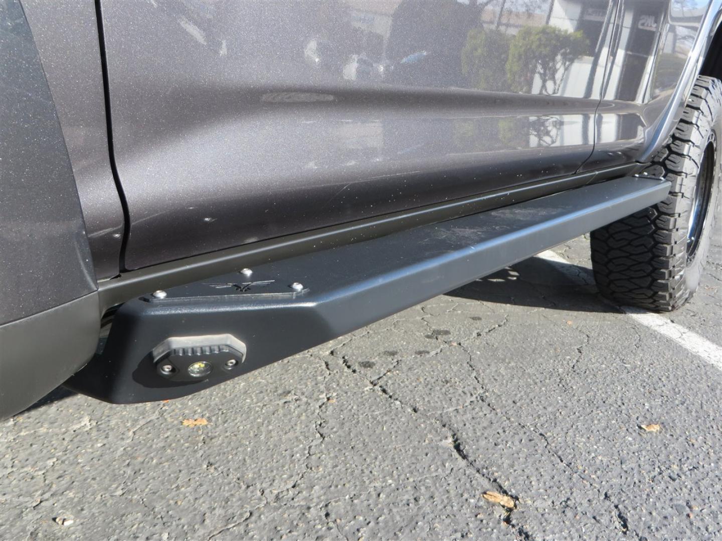 2021 grey /black Toyota 4Runner TRD Off-road Premium 4WD (JTERU5JR3M5) with an 4.0L V6 DOHC 24V engine, 5A transmission, located at 2630 Grass Valley Highway, Auburn, CA, 95603, (530) 508-5100, 38.937893, -121.095482 - Featuring Icon suspension, C4 front bumper, Victory 4x4 rear bumper with spare tire carrier, C4 ladder, Victory 4x4 roof rack, Victory 4x4 rock sliders, Baja designs LED's, 17'' KMC wheels, Maxxis Razr AT tires, and a Victory 4x4 rear cargo Molle panel. - Photo#11