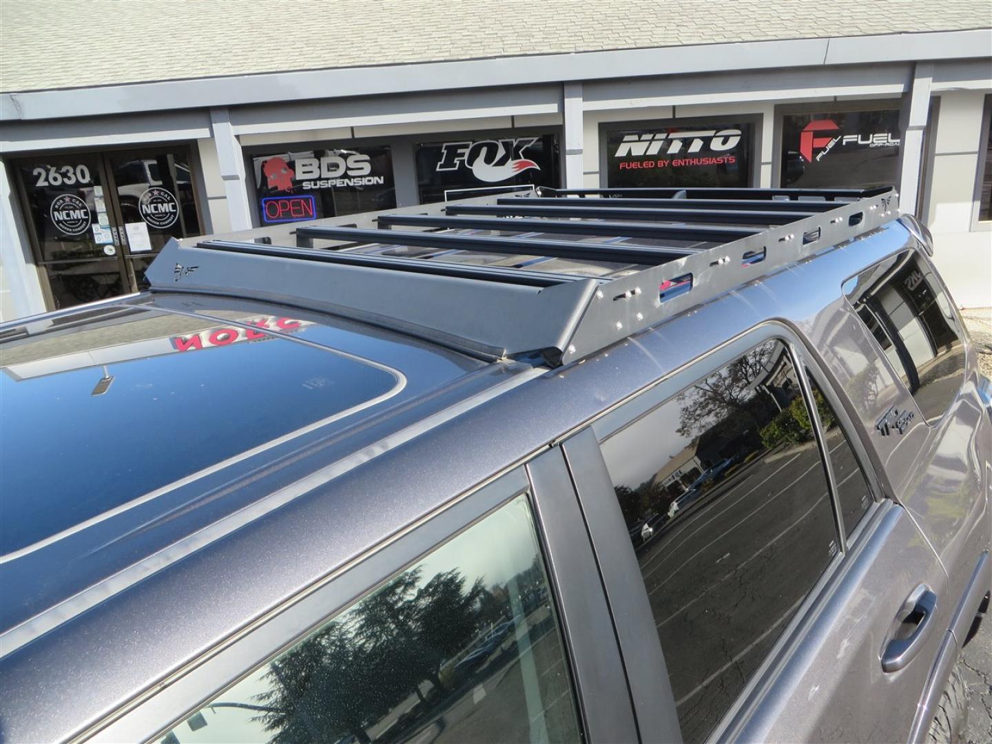 2021 grey /black Toyota 4Runner TRD Off-road Premium 4WD (JTERU5JR3M5) with an 4.0L V6 DOHC 24V engine, 5A transmission, located at 2630 Grass Valley Highway, Auburn, CA, 95603, (530) 508-5100, 38.937893, -121.095482 - Featuring Icon suspension, C4 front bumper, Victory 4x4 rear bumper with spare tire carrier, C4 ladder, Victory 4x4 roof rack, Victory 4x4 rock sliders, Baja designs LED's, 17'' KMC wheels, Maxxis Razr AT tires, and a Victory 4x4 rear cargo Molle panel. - Photo#14